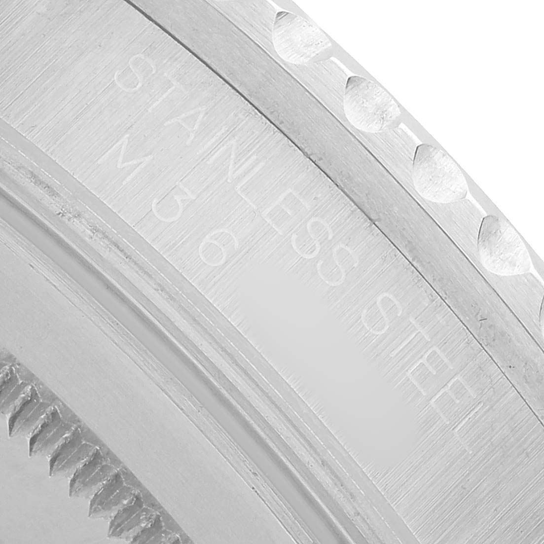 The image shows a close-up of the edge of the stainless steel bezel of the Rolex GMT-Master 16710 Men's Stainless Steel Black Dial watch.