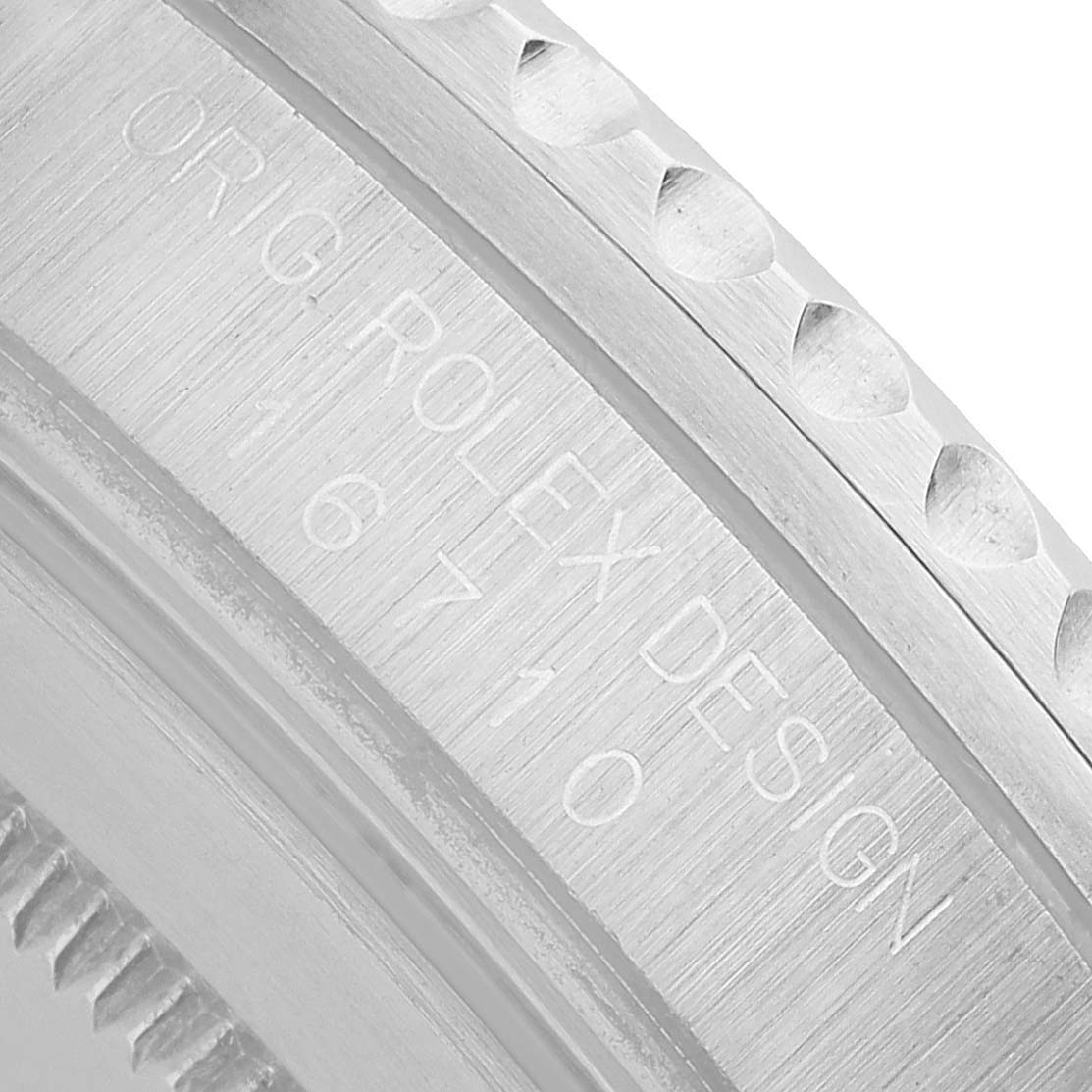 The image shows a close-up of the engraved bezel edge of a Rolex GMT-Master 16710 Men's Stainless Steel Black Dial model.