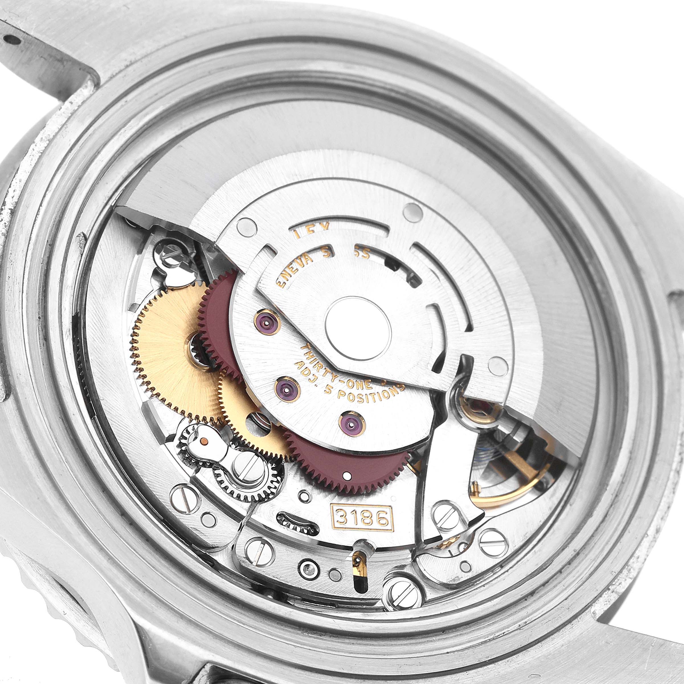 The image shows the internal movement of a Rolex GMT-Master 16710 Men's Stainless Steel Black Dial watch, focusing on gears and mechanisms from the back.