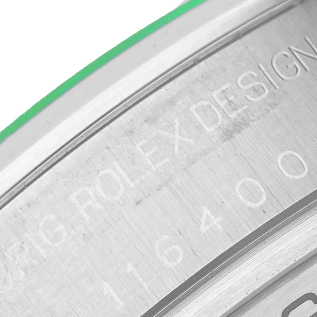 The image shows a close-up angle of the Rolex Milgauss 116400GV Men's Stainless Steel Black Dial 116400GV Men's Stainless Steel Black Dial model's engraved inner bezel with part of the model number visible.