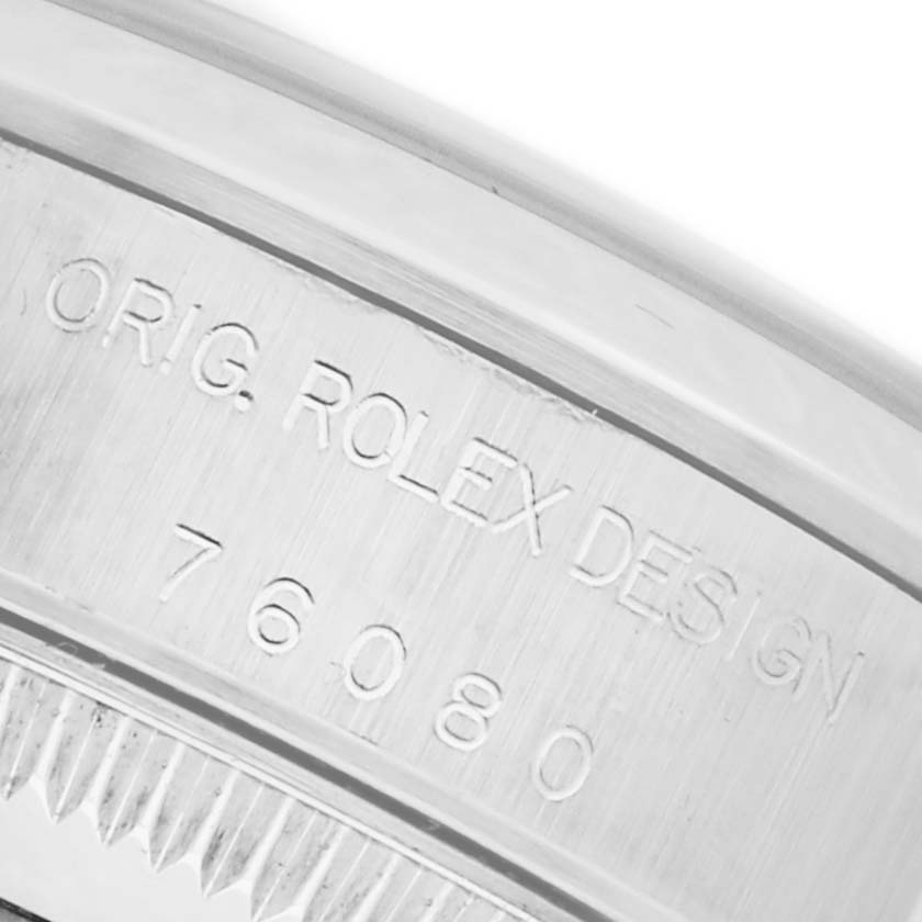 The image shows a close-up of the case edge with engraved "ORIG. ROLEX DESIGN" and the model number on a Rolex Oyster Perpetual 76080 Women's Stainless Steel Silver Dial 76080 Women's Stainless Steel Silver Dial watch.