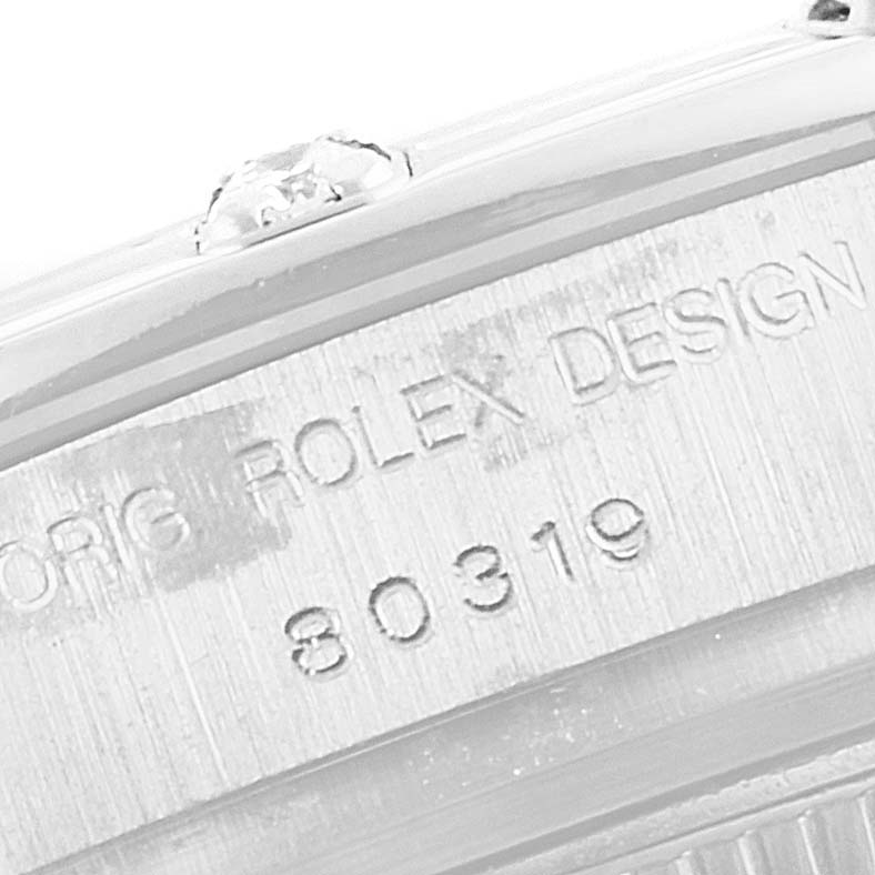 The image shows a close-up of the case inscribed with "ORIG ROLEX DESIGN 80319" of a Rolex Pearlmaster 80319 Women
s White Gold Silver Dial 80319 Women
s White Gold Silver Dial watch.