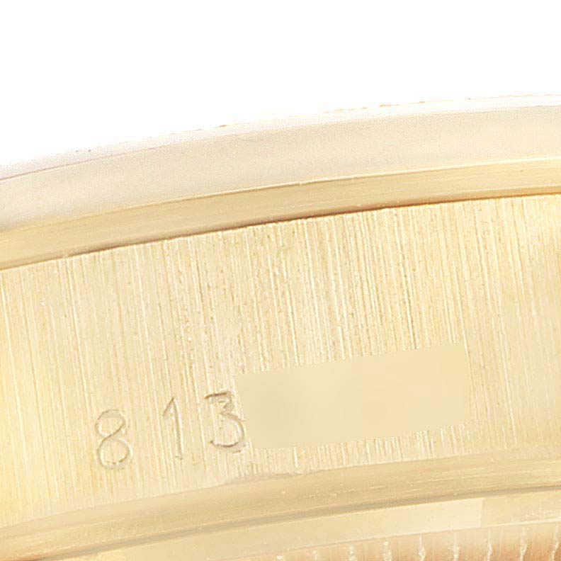 This image shows a close-up of the serial number engraving on the President model by Rolex.