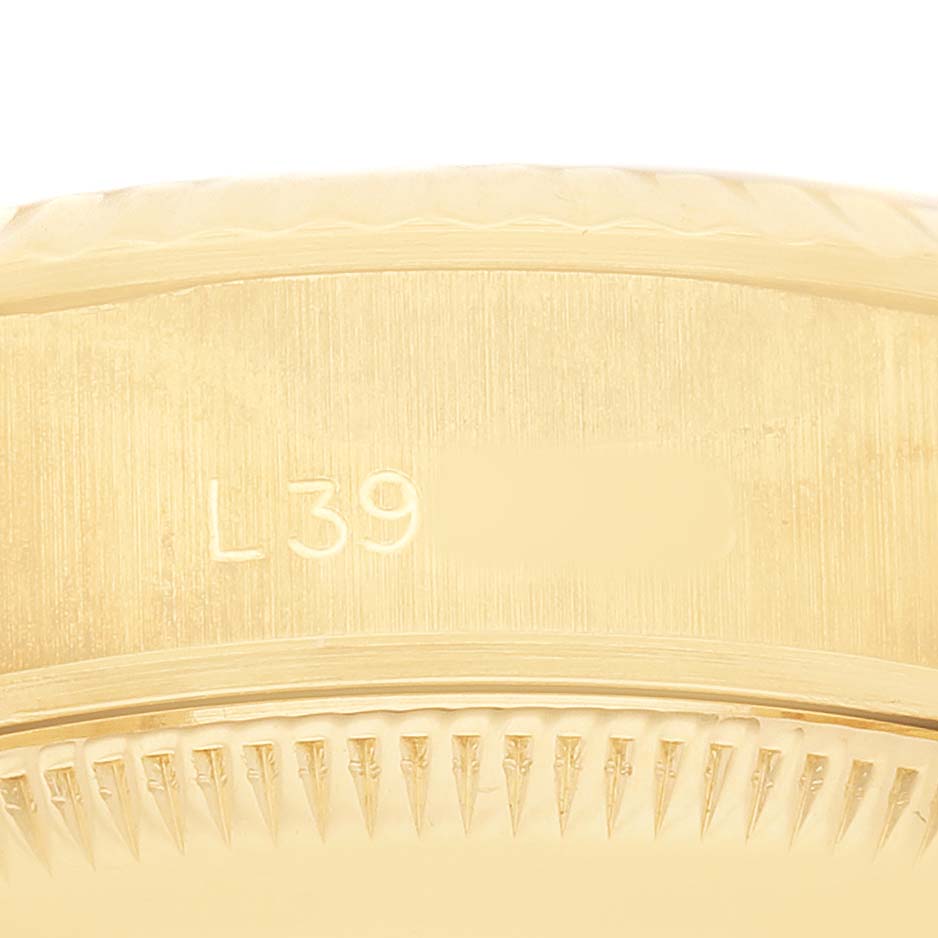 The image shows a close-up of the side of a Rolex President 69178 Women's Yellow Gold Champagne Dial model, highlighting the fluted bezel and engravings.