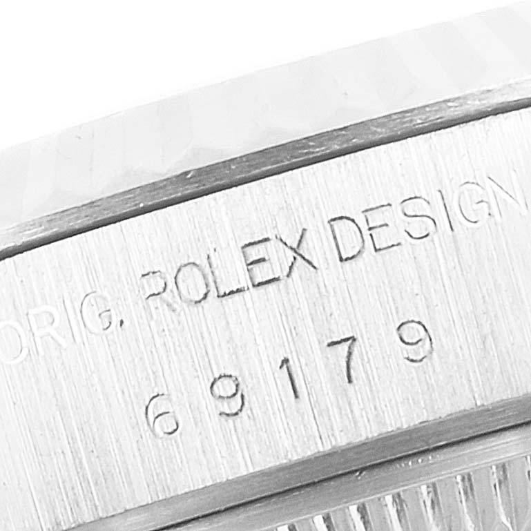 This close-up image shows the engraved branding and design markings on a Rolex President 69179 Women's White Gold Blue Dial 69179 Women's White Gold Blue Dial model watch.