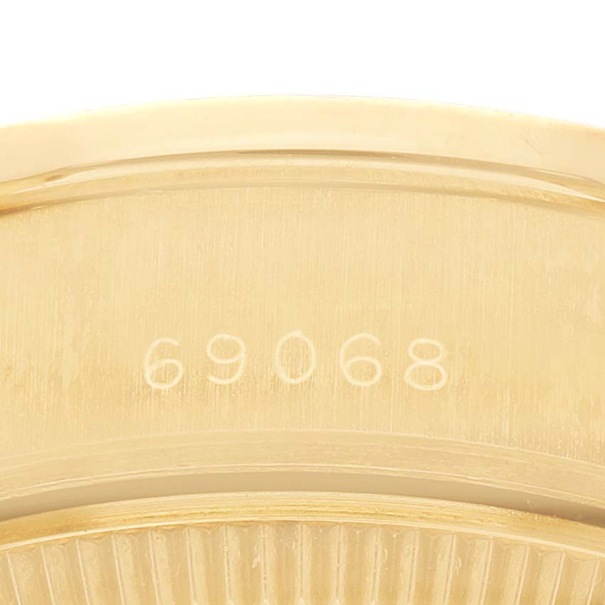 The Rolex President 69068 Women's Yellow Gold Champagne Dial model shows a close-up of the case's inner side, highlighting the model number "69068."