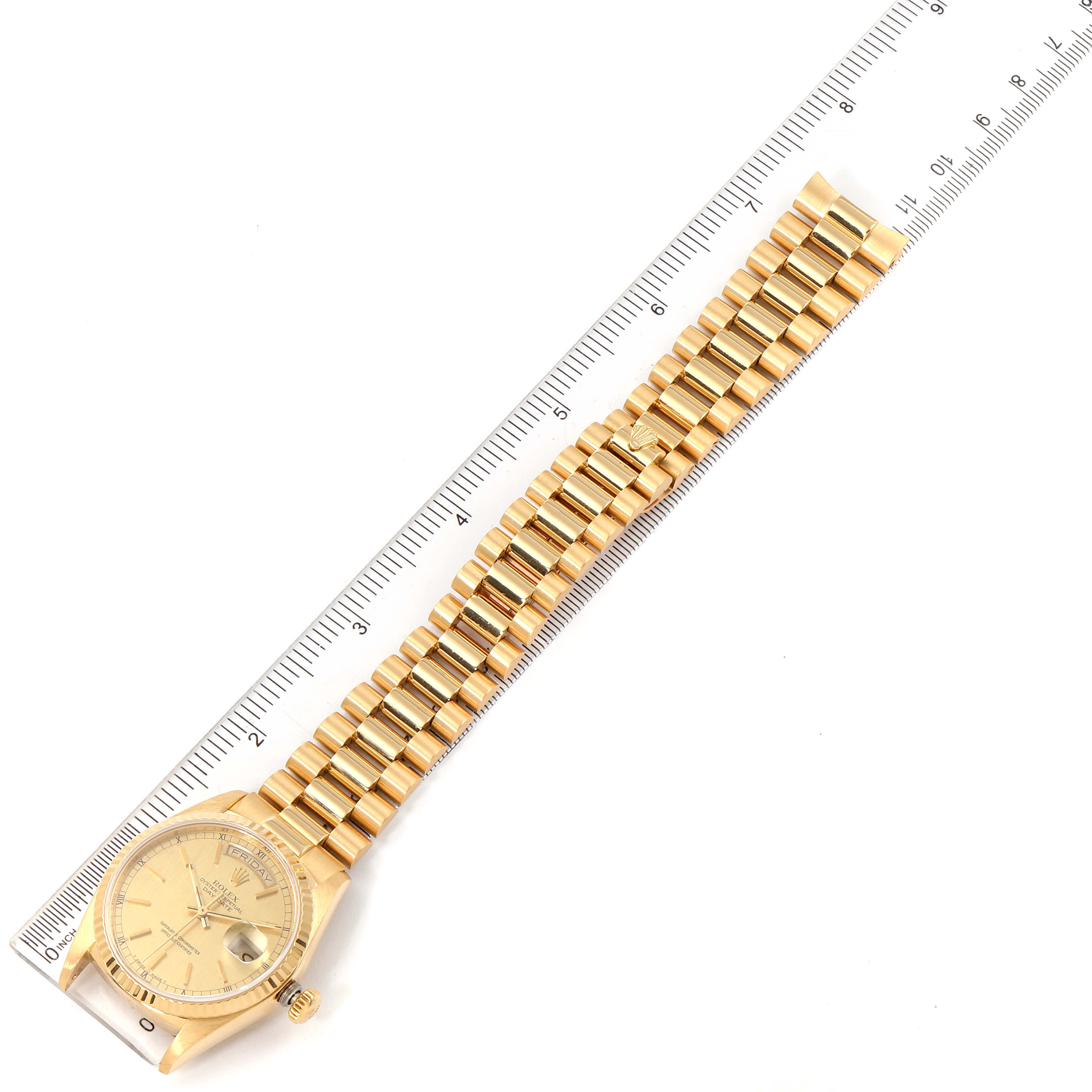 The image shows a gold Rolex President 18038 Men's Yellow Gold Champagne Dial 18038 Men's Yellow Gold Champagne Dial model watch with its bracelet extended and measured against a ruler.