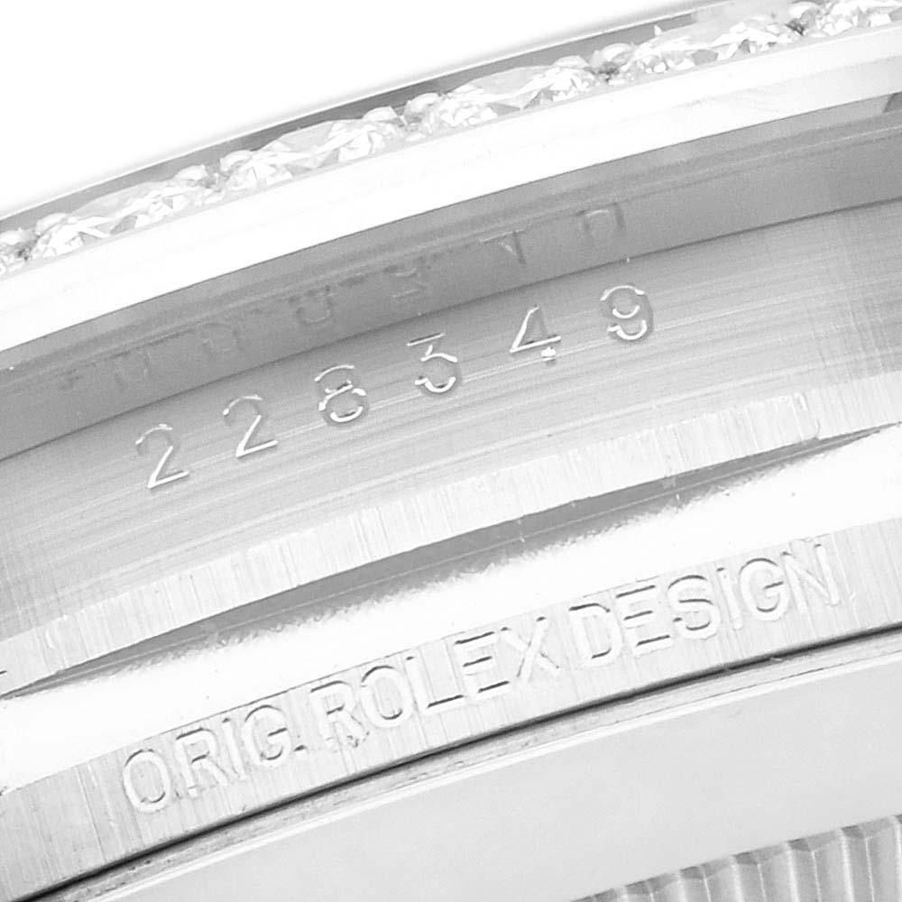 The image shows a close-up of the engraved inner bezel of a Rolex President 228349RBR Men's White Gold Black Dial 228349RBR Men's White Gold Black Dial watch, displaying serial numbers and "ORIG ROLEX DESIGN."