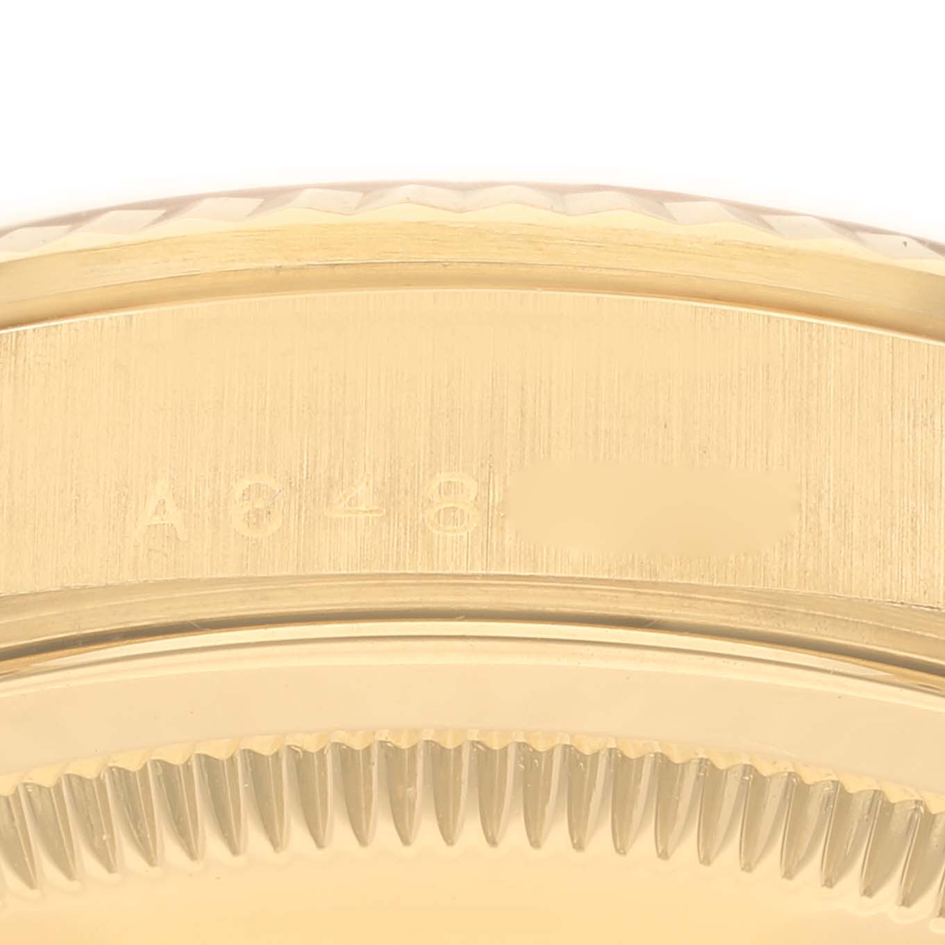 The image shows a close-up side view of the Rolex President 18238A Men
s Yellow Gold Champagne Dial 18238A Men
s Yellow Gold Champagne Dial watch, focusing on the serial number engraved on the case.
