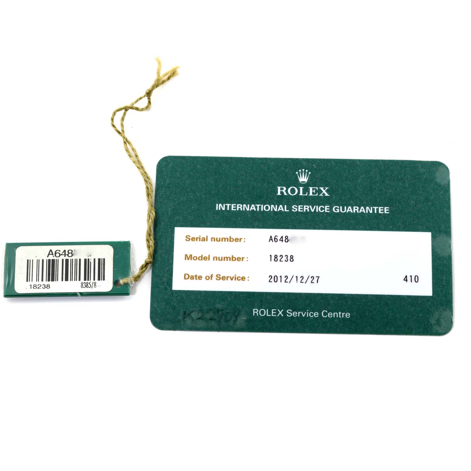 The image shows a green Rolex International Service Guarantee card and a matching tag for the Rolex President 18238A Men
s Yellow Gold Champagne Dial 18238A Men
s Yellow Gold Champagne Dial model 18238.