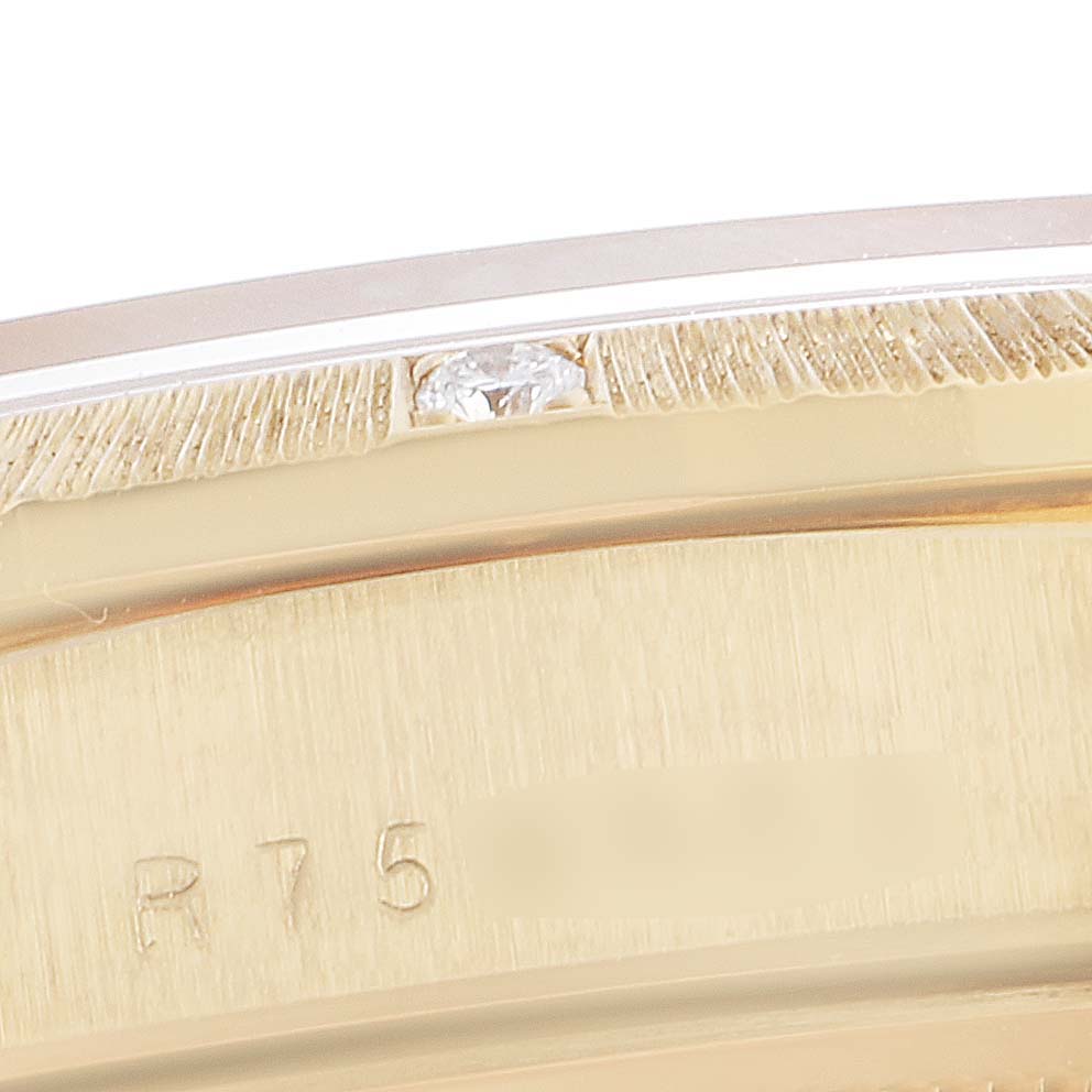 This close-up image shows the side of a Rolex President 18108 Men
s Yellow Gold Champagne Dial 18108 Men
s Yellow Gold Champagne Dial model watch
s gold case with detailed engravings and a diamond accent.