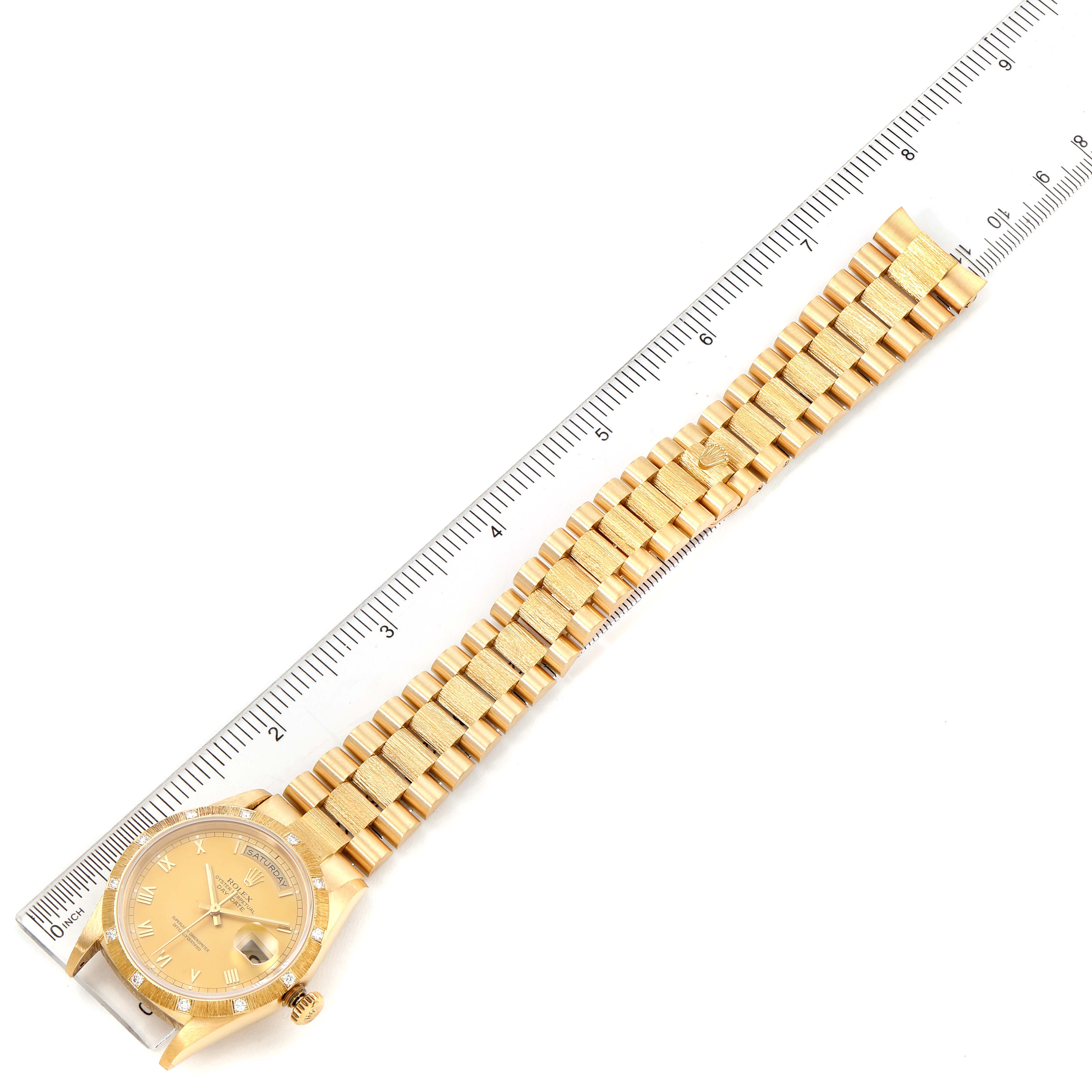 The image shows a Rolex President 18108 Men
s Yellow Gold Champagne Dial 18108 Men
s Yellow Gold Champagne Dial model watch with a gold bracelet, laid flat next to a ruler for scale.