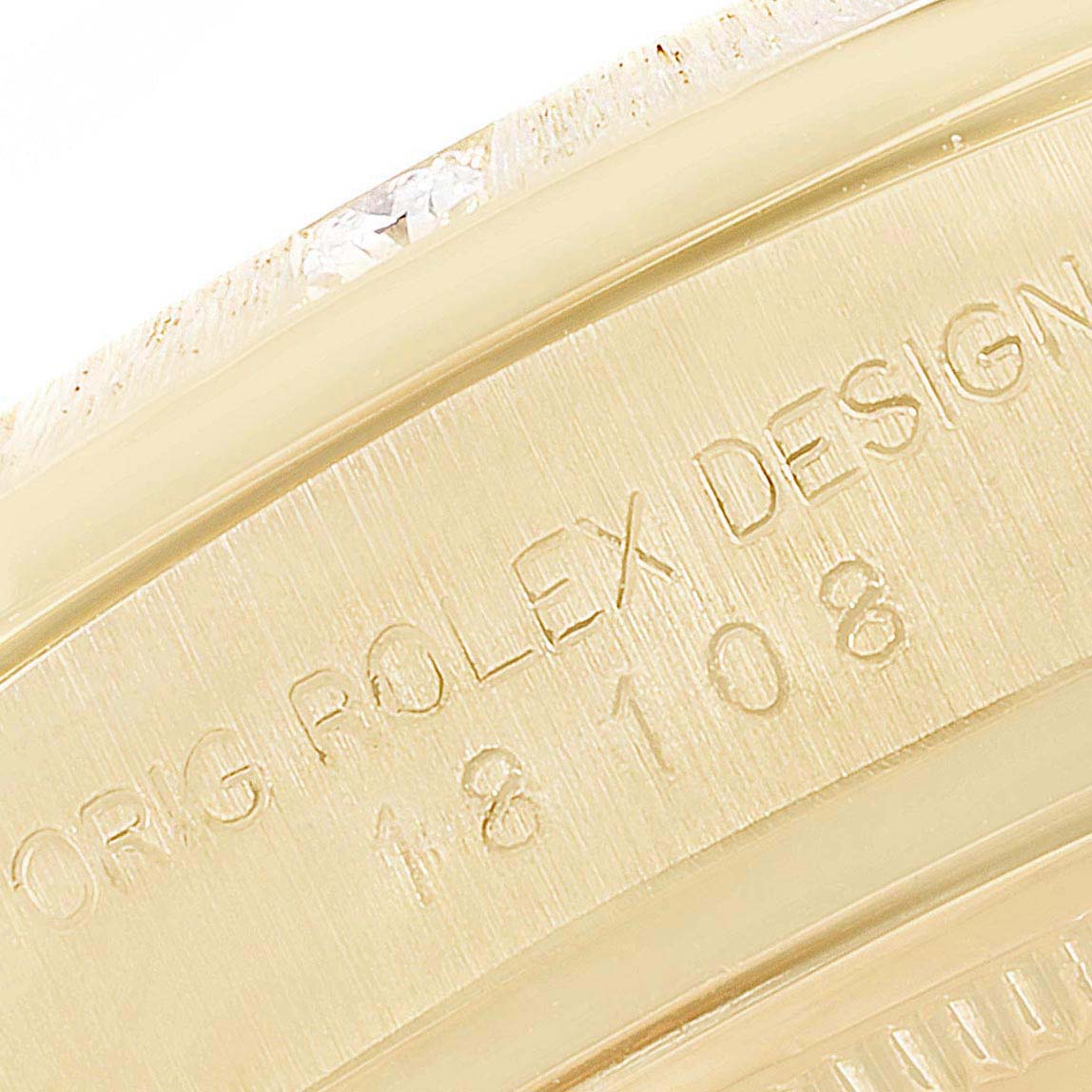 This close-up image shows the side of the Rolex President 18108 Men
s Yellow Gold Champagne Dial 18108 Men
s Yellow Gold Champagne Dial model, highlighting the engraved model number and part of the bezel.