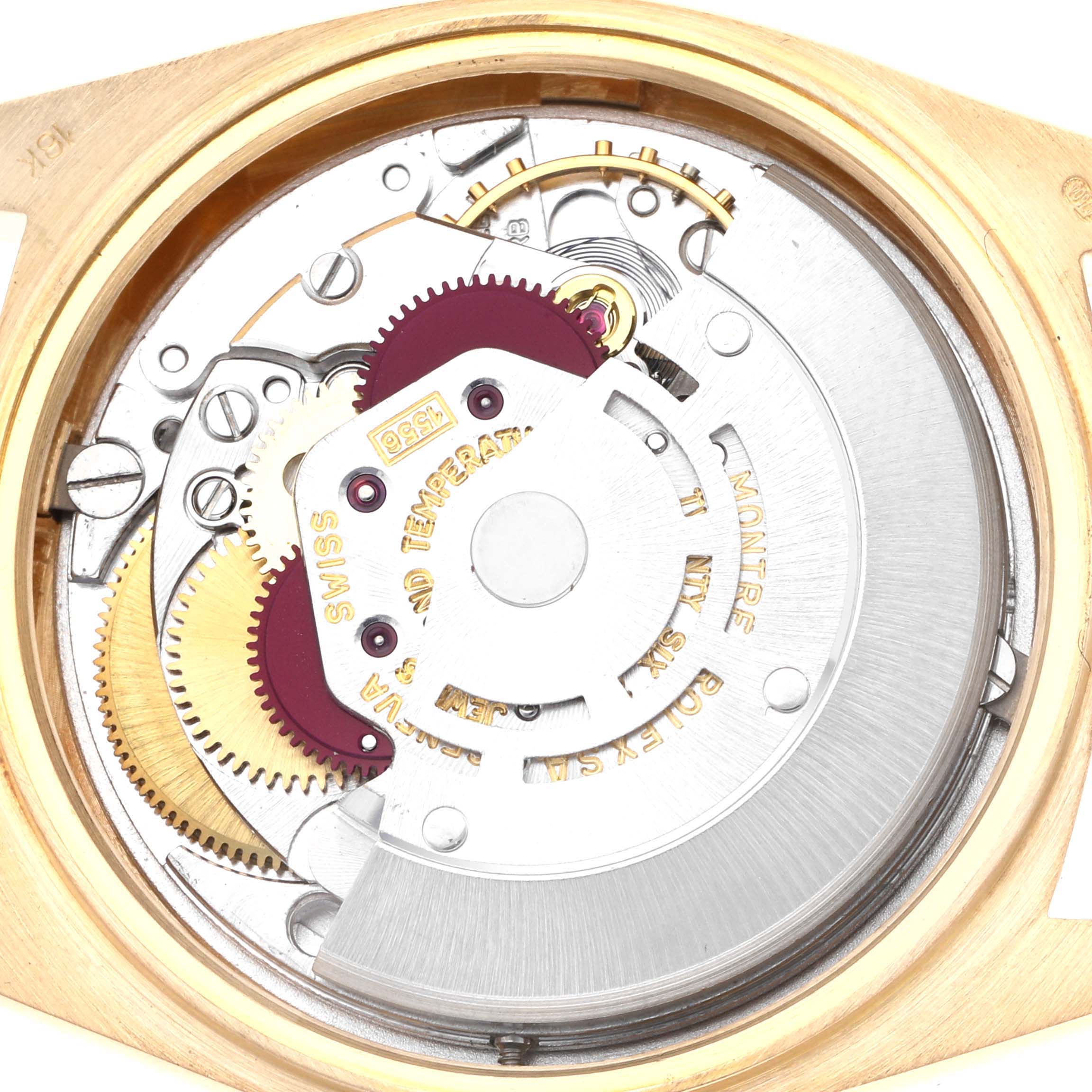 The image shows the movement of a Rolex President 1807 Men's Yellow Gold Champagne Dial model, viewed from the back, highlighting gears and intricate components.