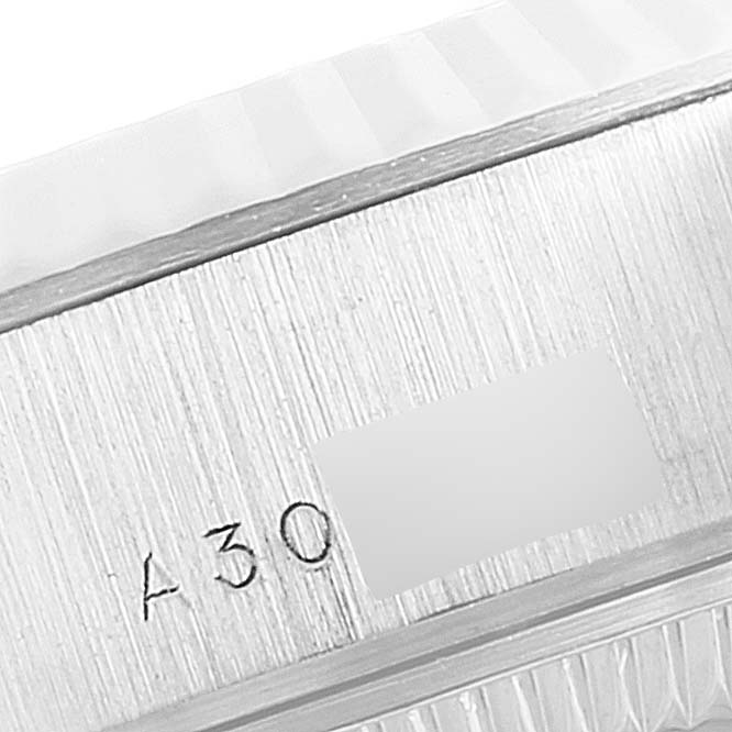 The image shows a close-up of the brushed side of a Rolex President 79179 Women's White Gold Silver Dial 79179 Women's White Gold Silver Dial model watch case, including part of the bezel and engraved markings.