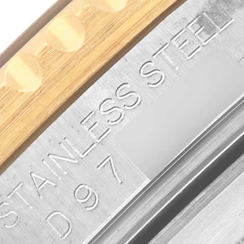 The image shows a close-up angle of the side of a Rolex Submariner 16613 Men's Steel and Gold (two tone) Blue Dial 16613 Men's Steel and Gold (two tone) Blue Dial's bezel and stainless steel case.