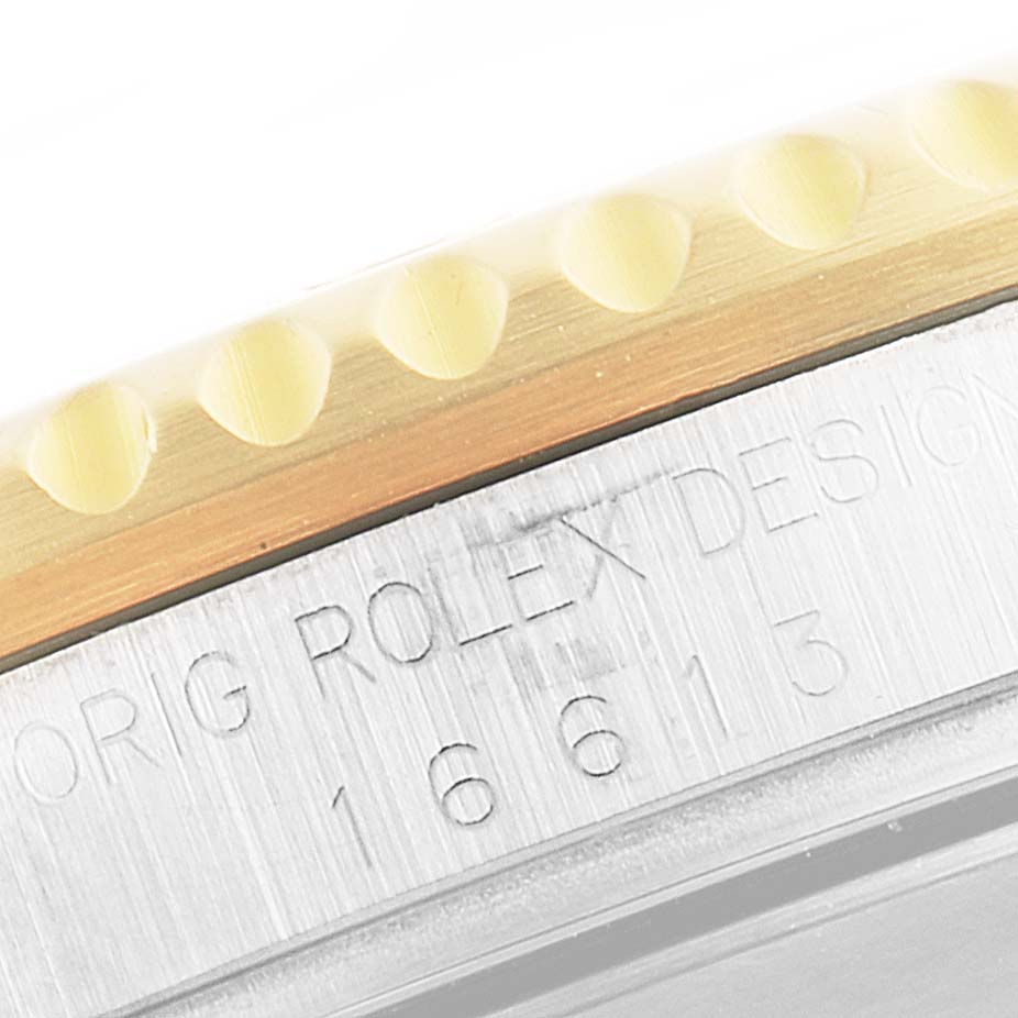 The image shows a close-up of the side of a Rolex Submariner 16613 Men
s Steel and Gold (two tone) Blue Dial 16613 Men
s Steel and Gold (two tone) Blue Dial watch, highlighting the model number and the bezel.