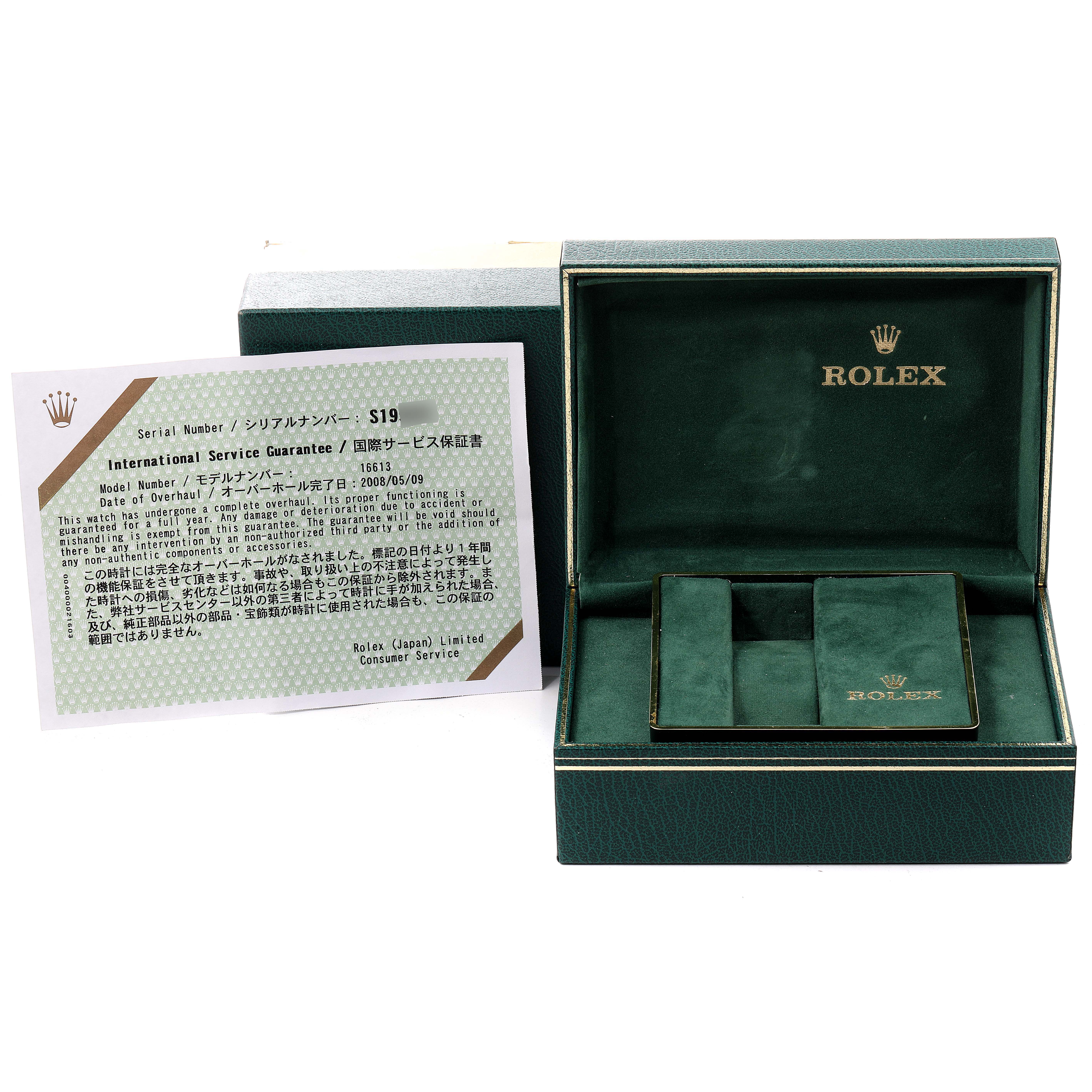 The image shows a Rolex Submariner 16613 Men
s Steel and Gold (two tone) Blue Dial 16613 Men
s Steel and Gold (two tone) Blue Dial watch box with an International Service Guarantee card displayed at an angle.