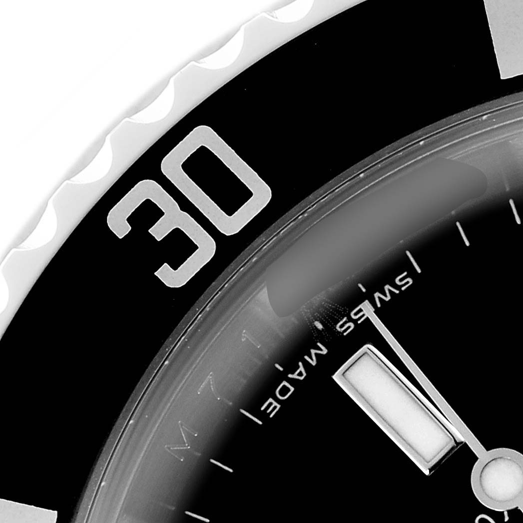 The image shows a close-up of the bezel and dial of a Rolex Submariner 16610T Men's Stainless Steel Black Dial 16610T Men's Stainless Steel Black Dial, highlighting the "30" minute marker and part of the hands.