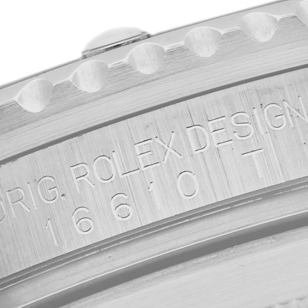 The image shows a close-up of the bezel and engraved side of a Rolex Submariner 16610T Men's Stainless Steel Black Dial 16610T Men's Stainless Steel Black Dial watch.