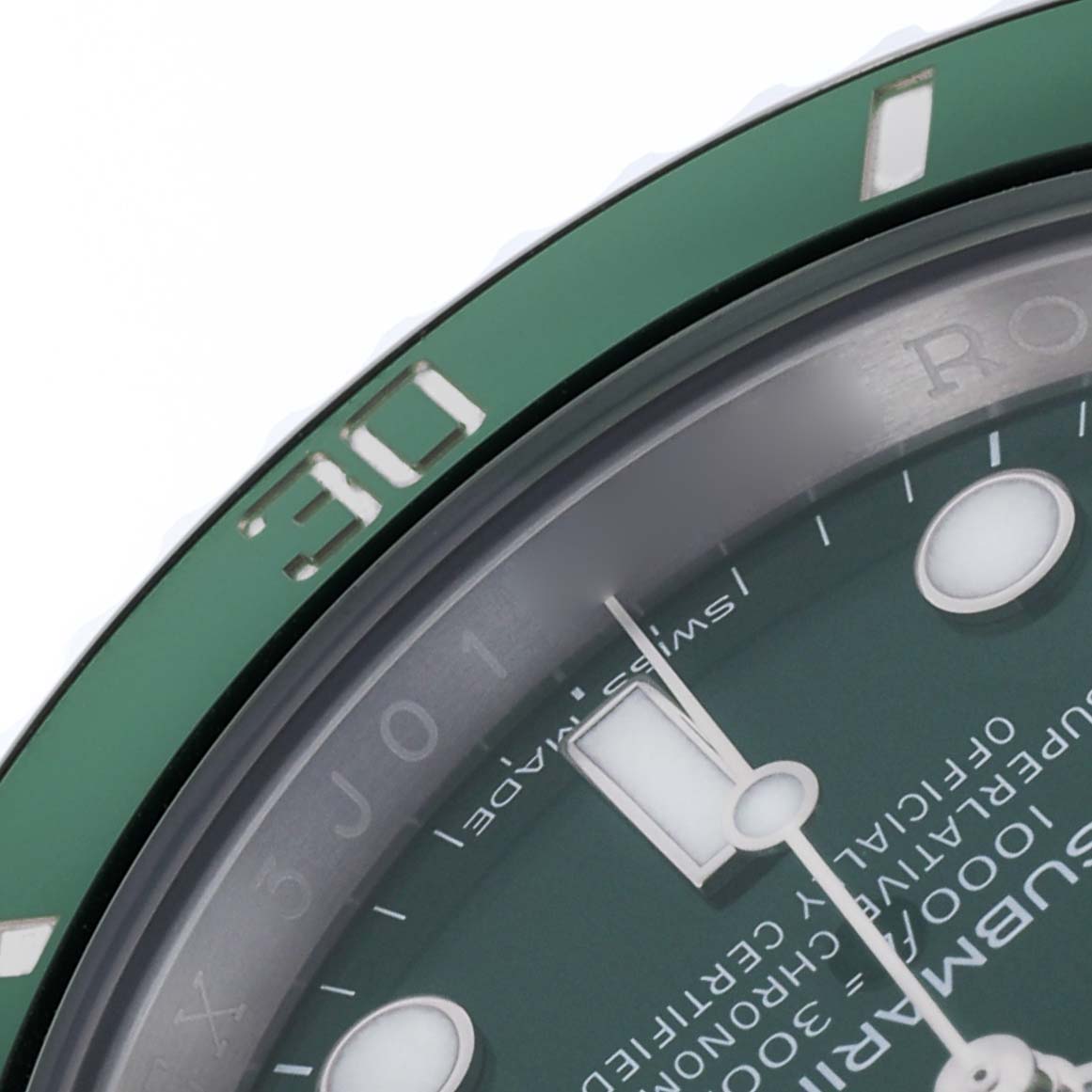 The image shows a close-up of the Rolex Submariner 116610LV Men's Stainless Steel Green Dial 116610LV Men's Stainless Steel Green Dial's green bezel and partial dial.