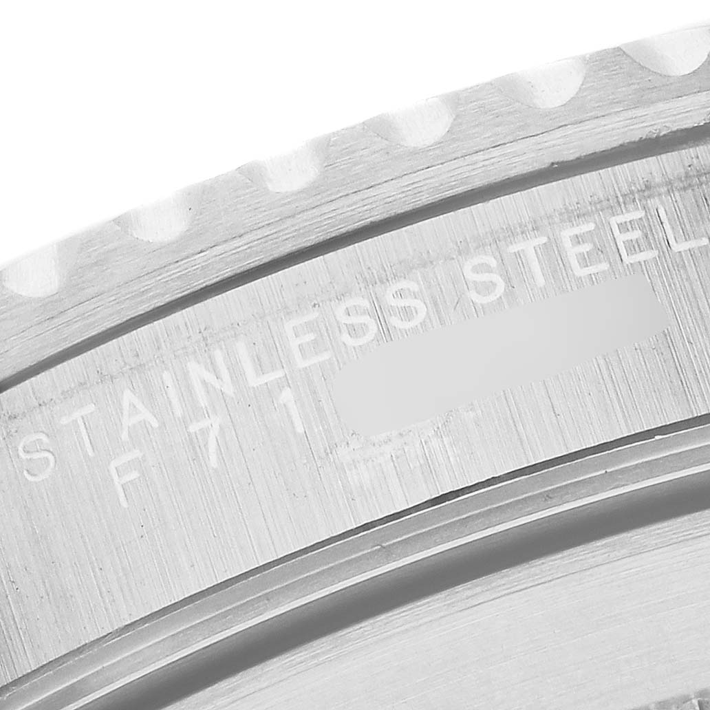 The image shows a close-up of the case back edge of a Rolex Submariner 14060 Men's Stainless Steel Black Dial watch, focusing on the engraved text and stainless steel material.