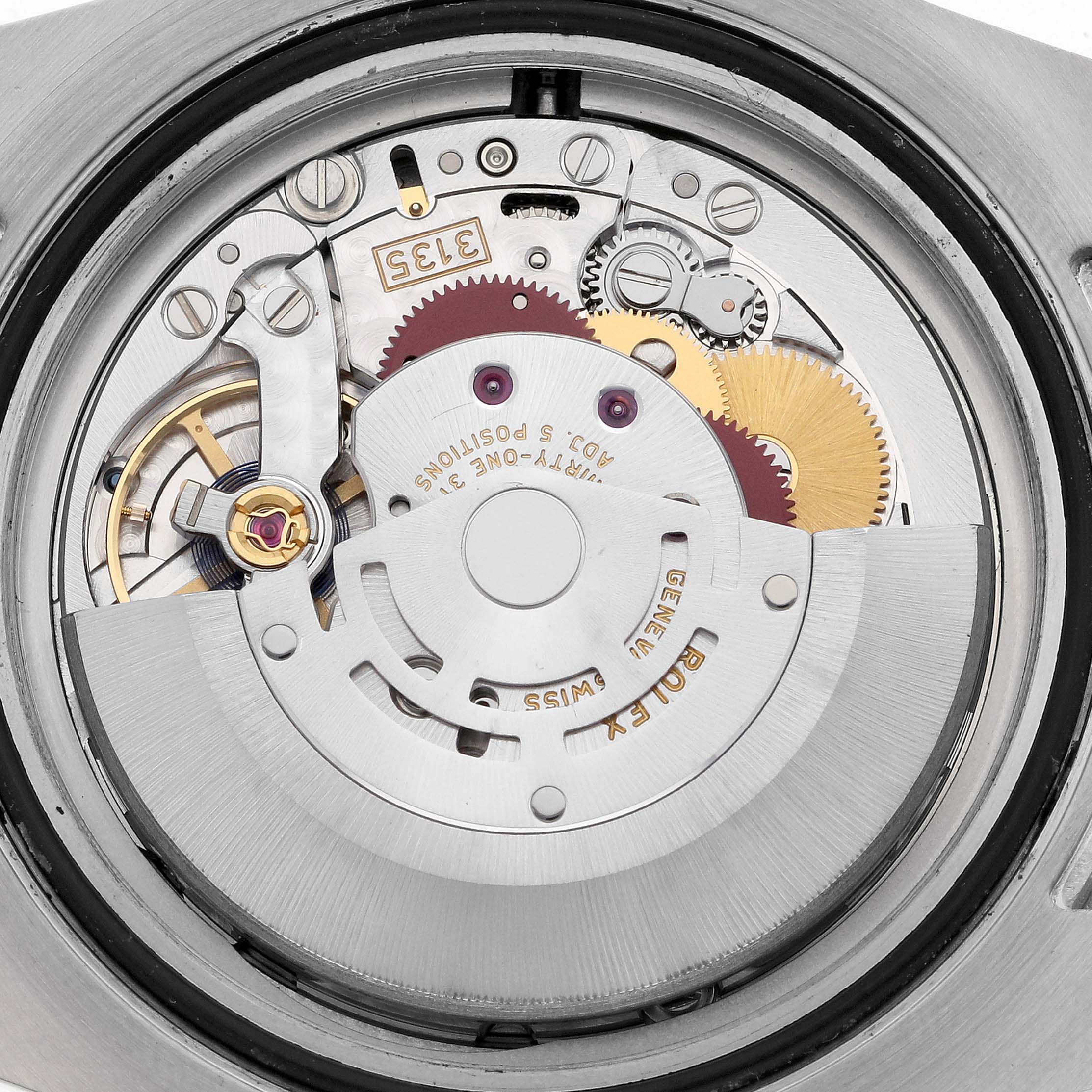 The image shows the movement of a Rolex Submariner 116613LN Men's Steel and Gold (two tone) Black Dial 116613LN Men's Steel and Gold (two tone) Black Dial watch, focusing on the intricate gears and mechanics from a back angle.