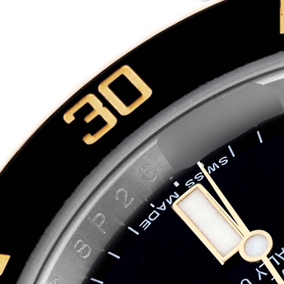 The image shows a close-up of the Rolex Submariner 116613LN Men's Steel and Gold (two tone) Black Dial 116613LN Men's Steel and Gold (two tone) Black Dial's bezel and part of the dial, highlighting the "30" marker and watch hand.