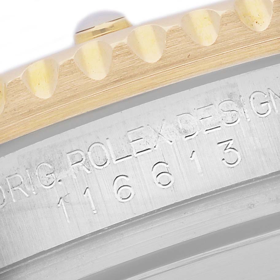 The image shows a close-up of the bezel and engraved case side of a Rolex Submariner 116613LN Men's Steel and Gold (two tone) Black Dial 116613LN Men's Steel and Gold (two tone) Black Dial watch.