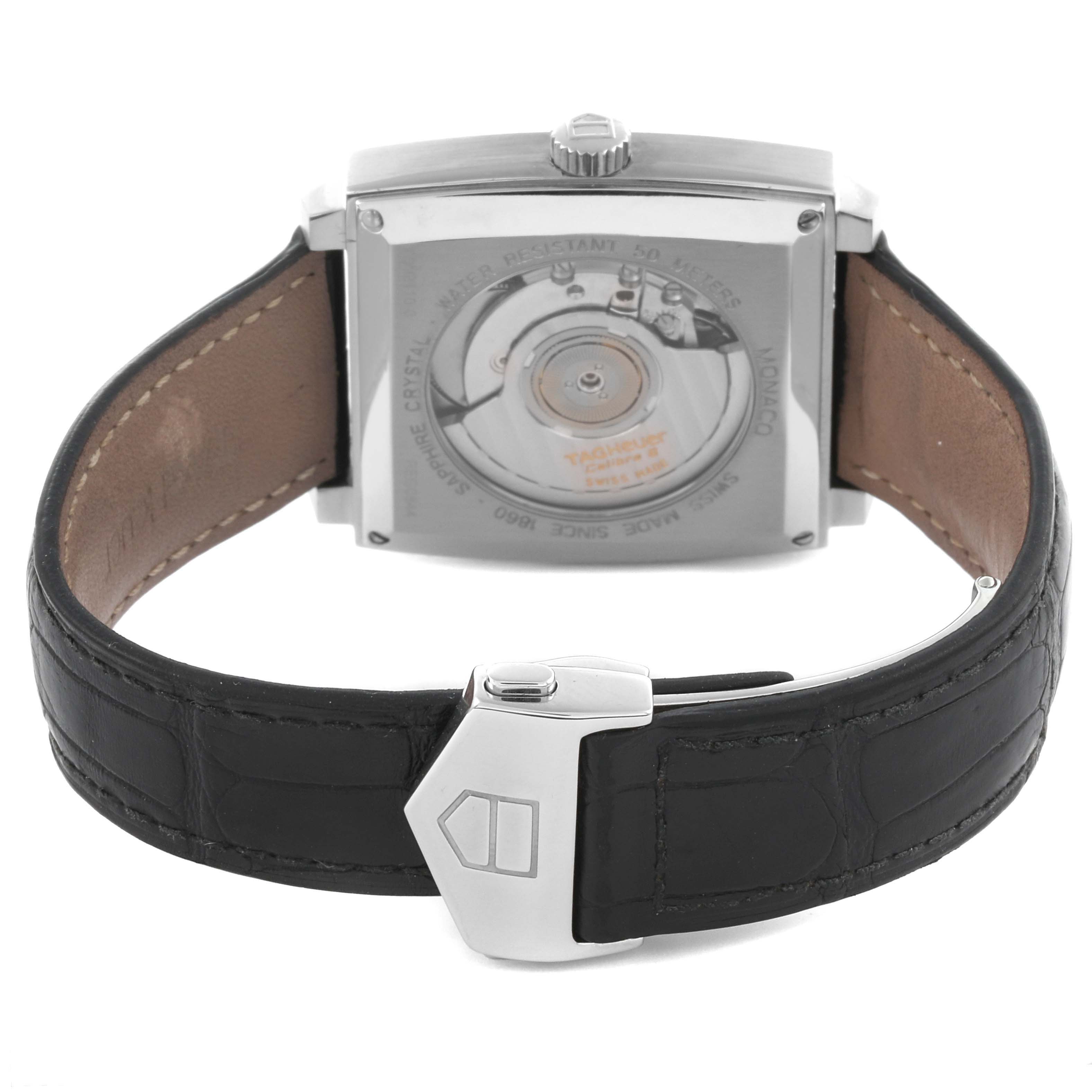 The Tag Heuer Monaco WW2110.FC6177 Men's Stainless Steel Black Dial WW2110.FC6177 Men's Stainless Steel Black Dial watch is shown from the back, featuring the visible movement and leather strap with clasp.