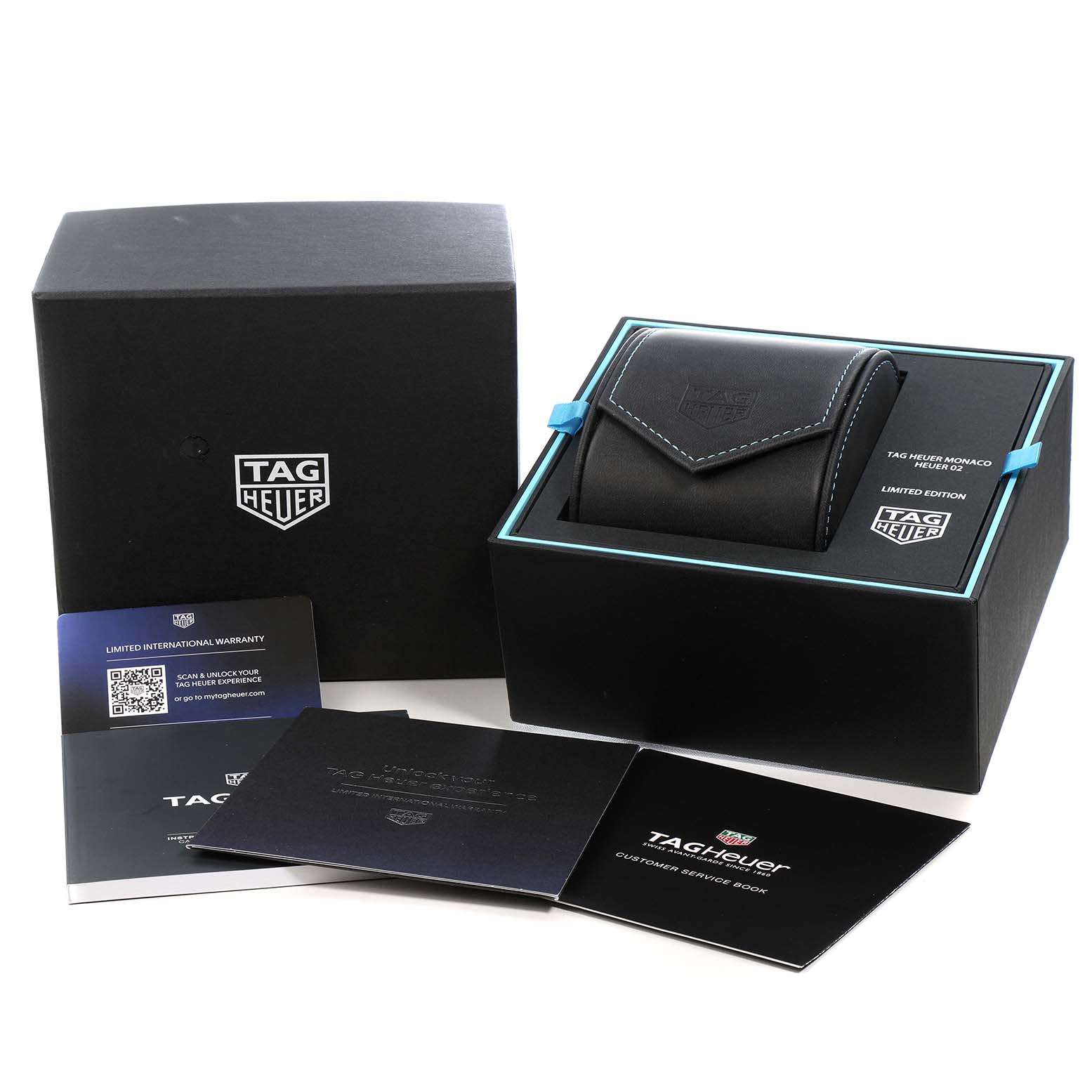 The image shows the Tag Heuer Monaco CBL2181 Men's Titanium Grey Dial packaging and accessories, including a box, pouch, and documents.