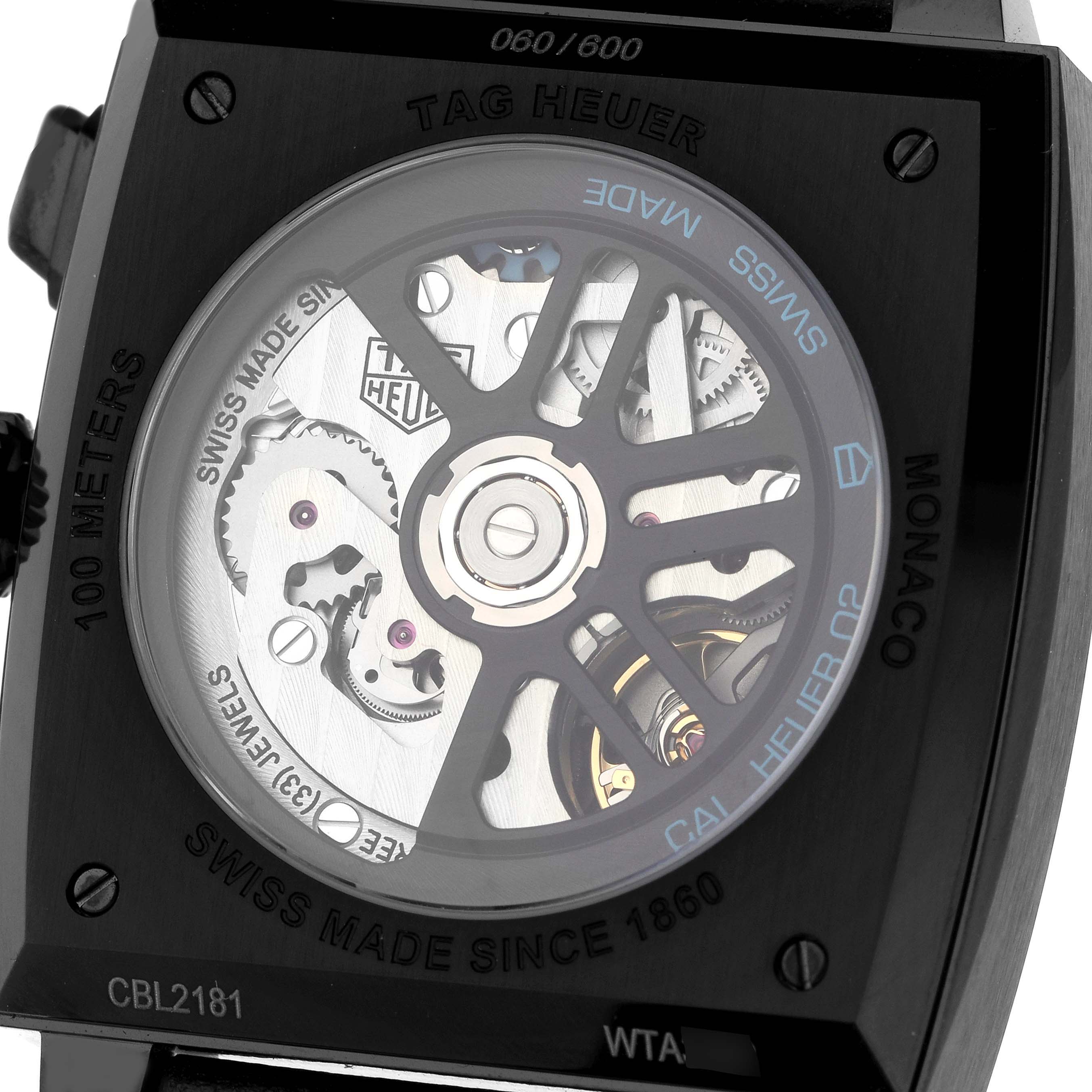 The image shows the back view of the Tag Heuer Monaco CBL2181 Men's Titanium Grey Dial watch, revealing its intricate movement and rotor.
