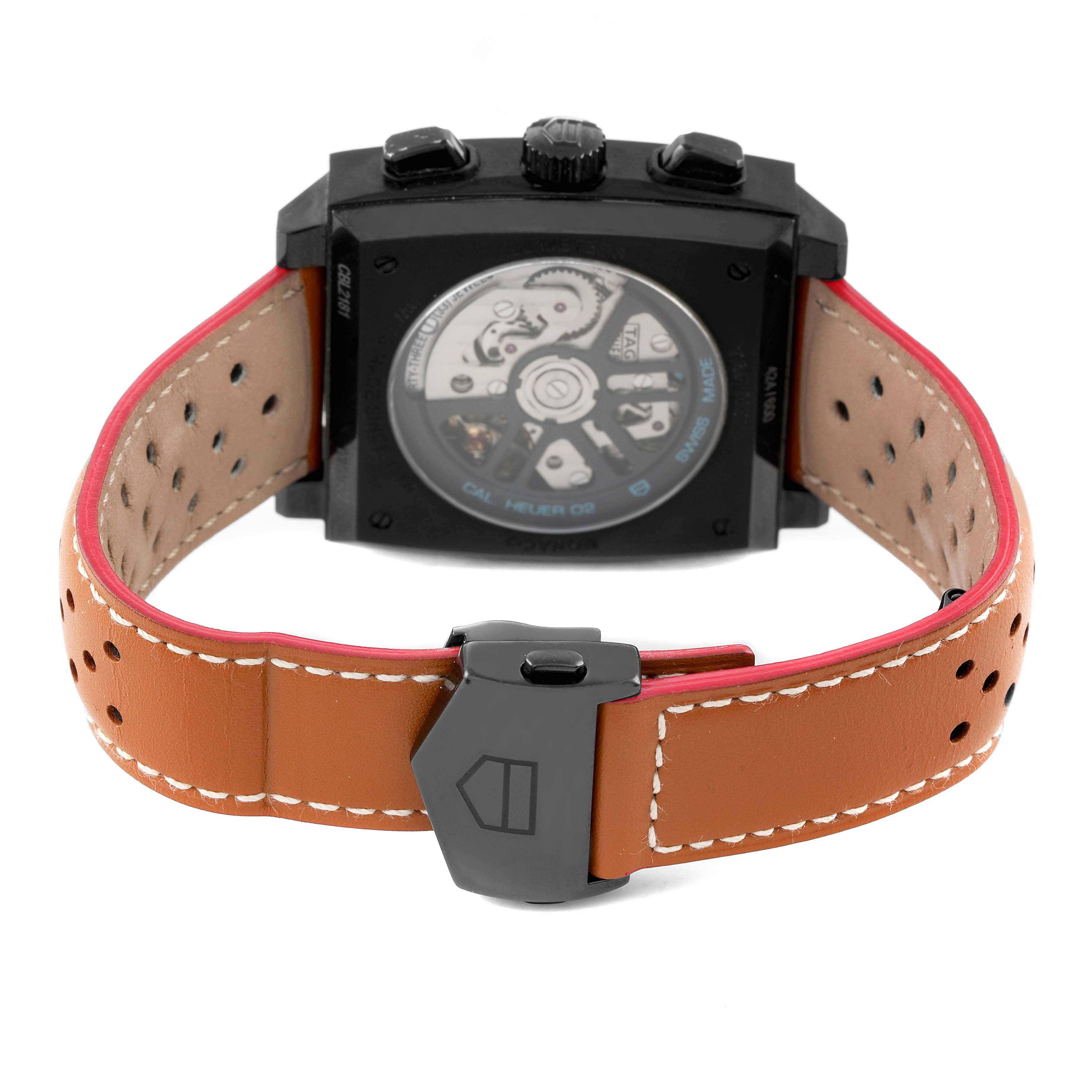 The image shows the back view of a Tag Heuer Monaco CBL2181 Men's Titanium Grey Dial watch, highlighting its open case back and tan perforated strap.