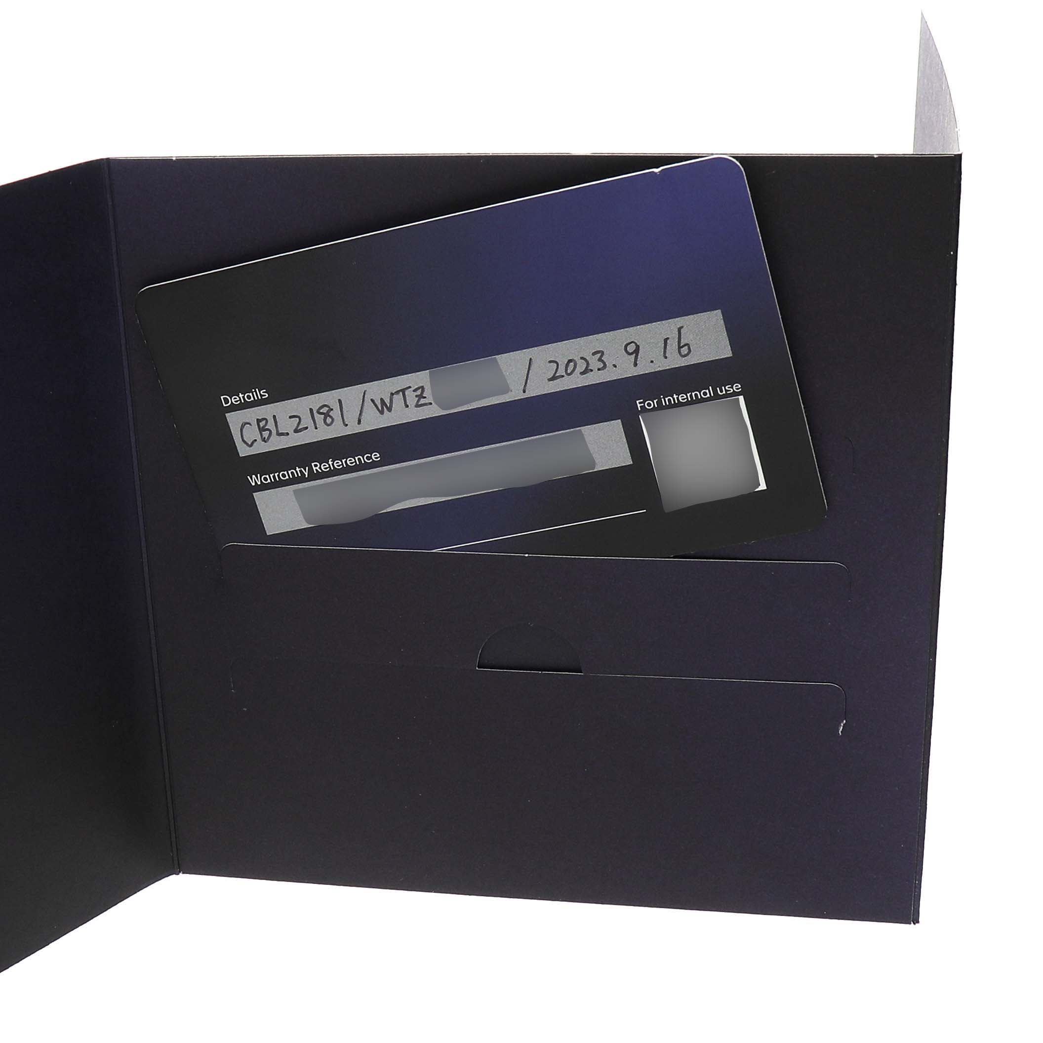 The image shows a warranty card for the Tag Heuer Monaco CBL2181 Men's Titanium Grey Dial model inside a dark folder.