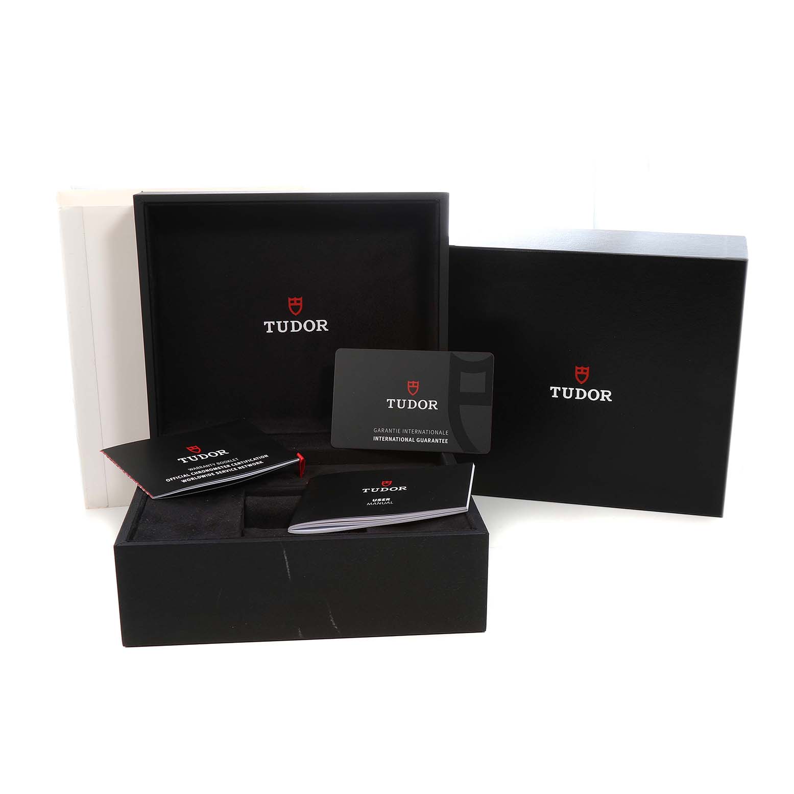 The image shows the Tudor Heritage Black Bay 79030 Men's Stainless Steel Blue Dial packaging, including the box, warranty card, and manuals.