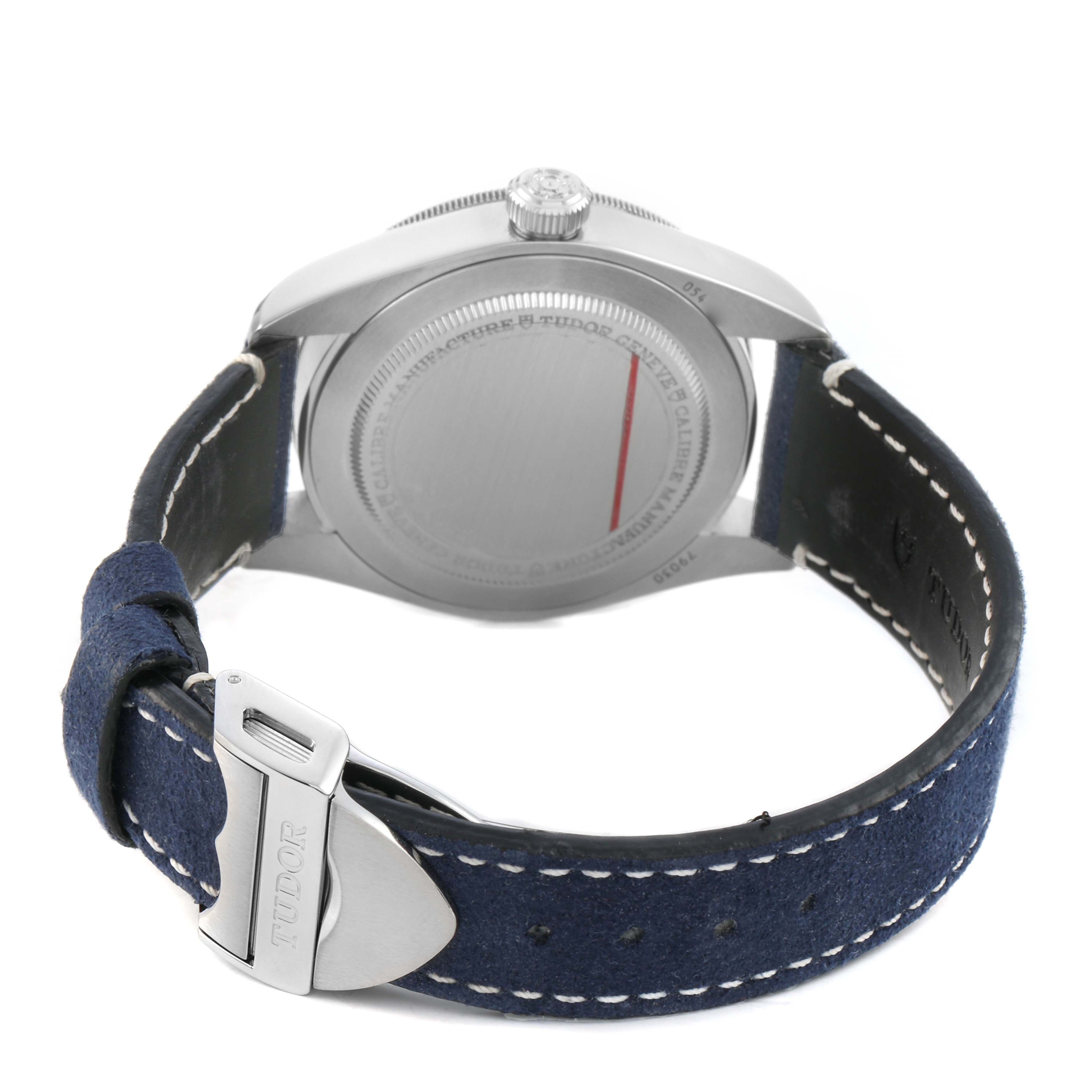 The Tudor Heritage Black Bay 79030 Men's Stainless Steel Blue Dial watch is shown from the back, highlighting the case back, crown, and leather strap with buckle.