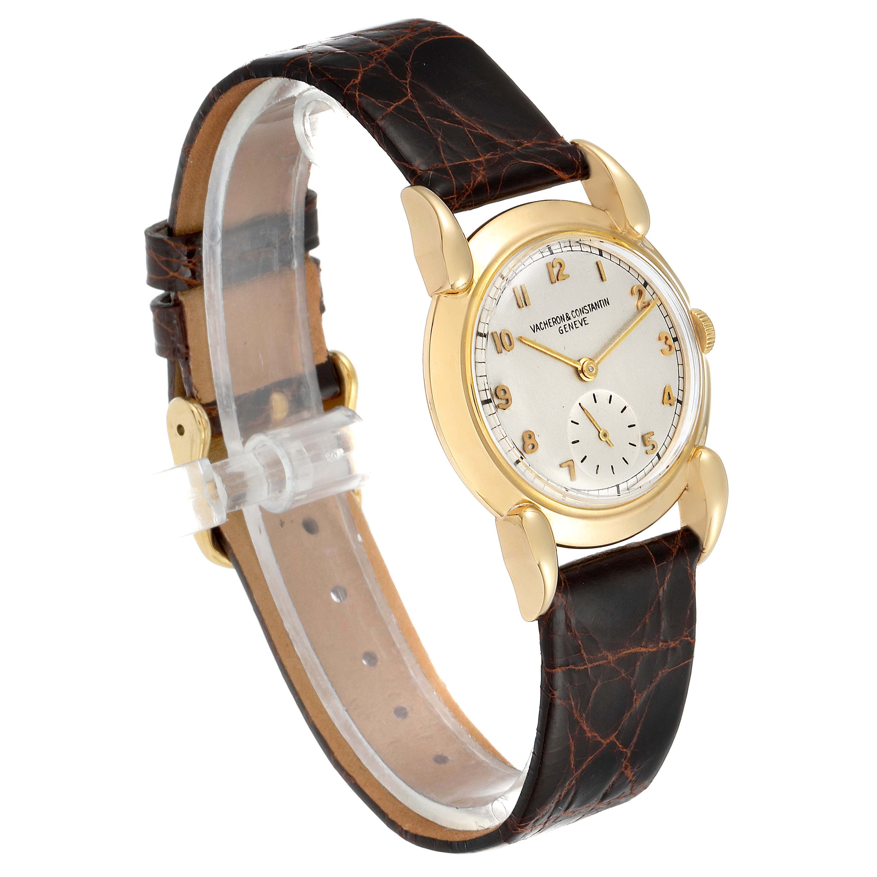 The image shows a side angle of a Vintage Vacheron Constantin watch, featuring its gold case, leather strap, and white dial.