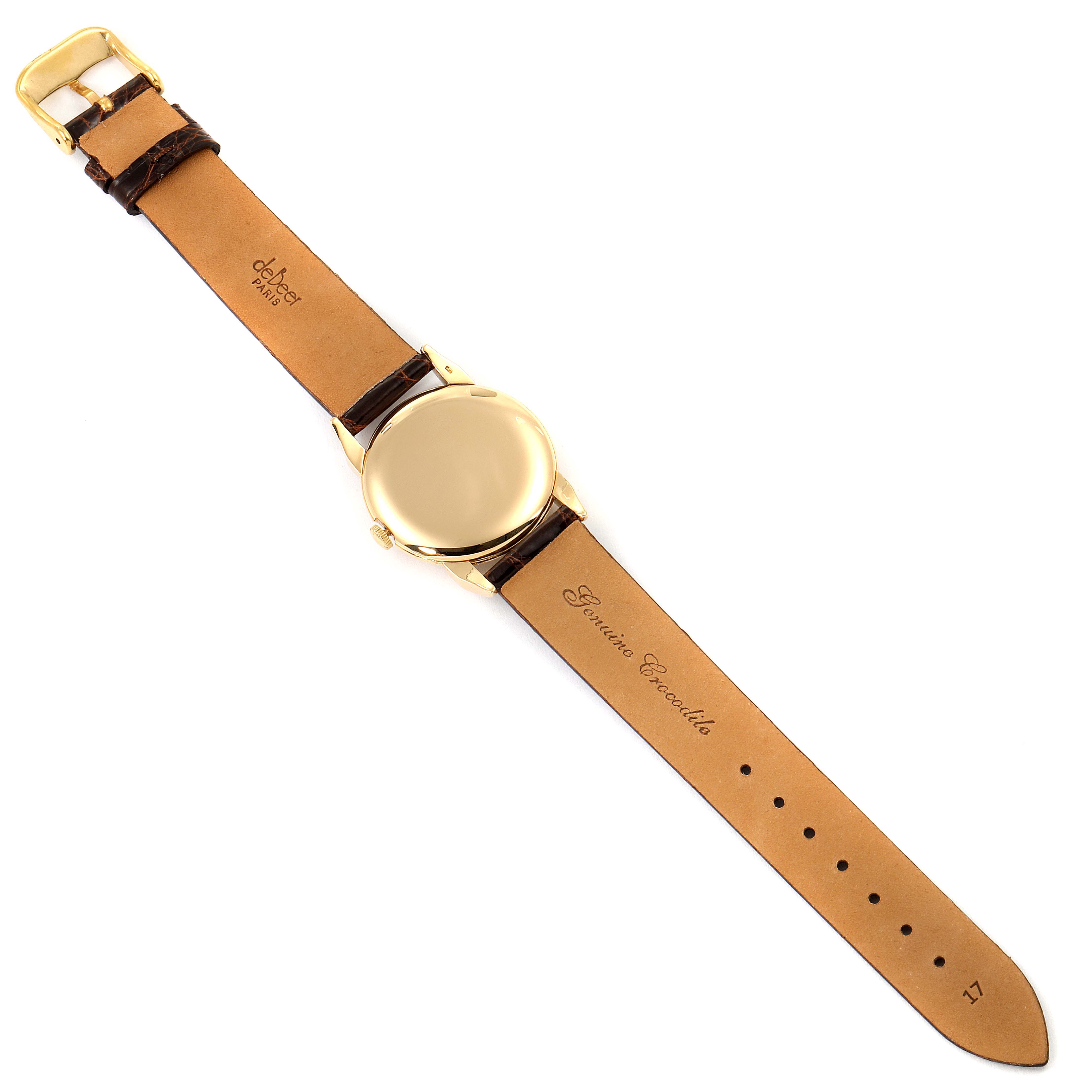 The image shows a Vacheron Constantin Vintage Women's Yellow Gold Silver Dial Women's Yellow Gold Silver Dial watch from the back, displaying the leather strap and gold case.