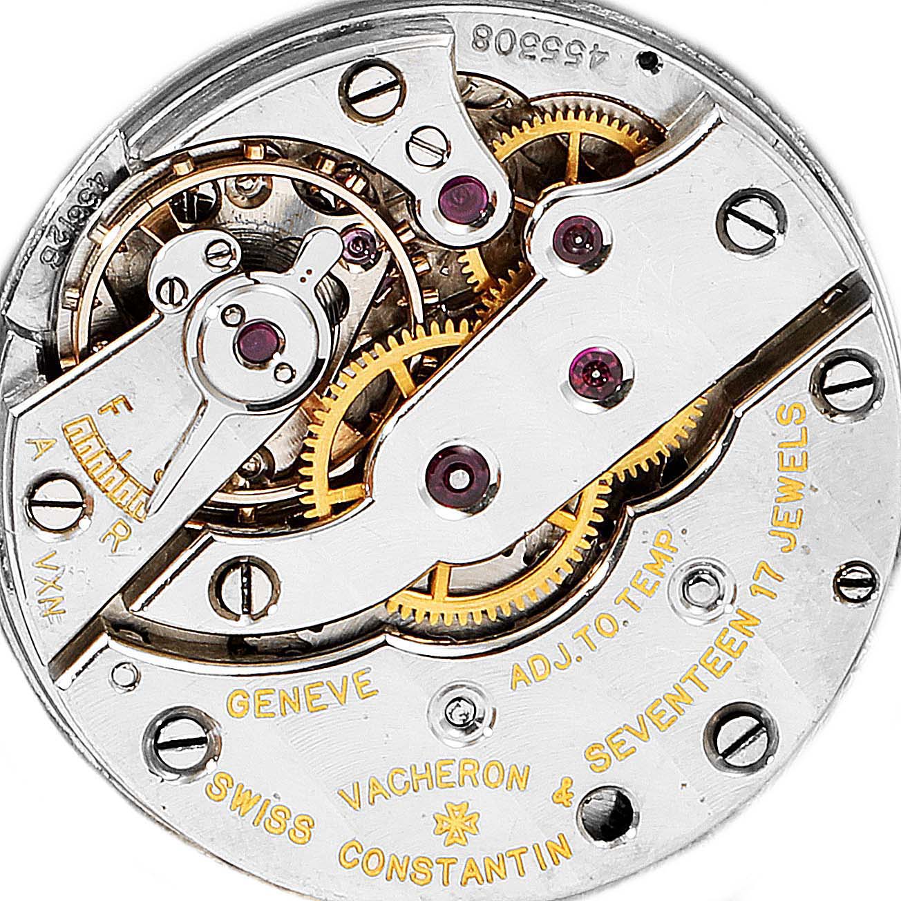 The image shows the intricate mechanical movement of a Vintage Vacheron Constantin watch, viewed from the back.
