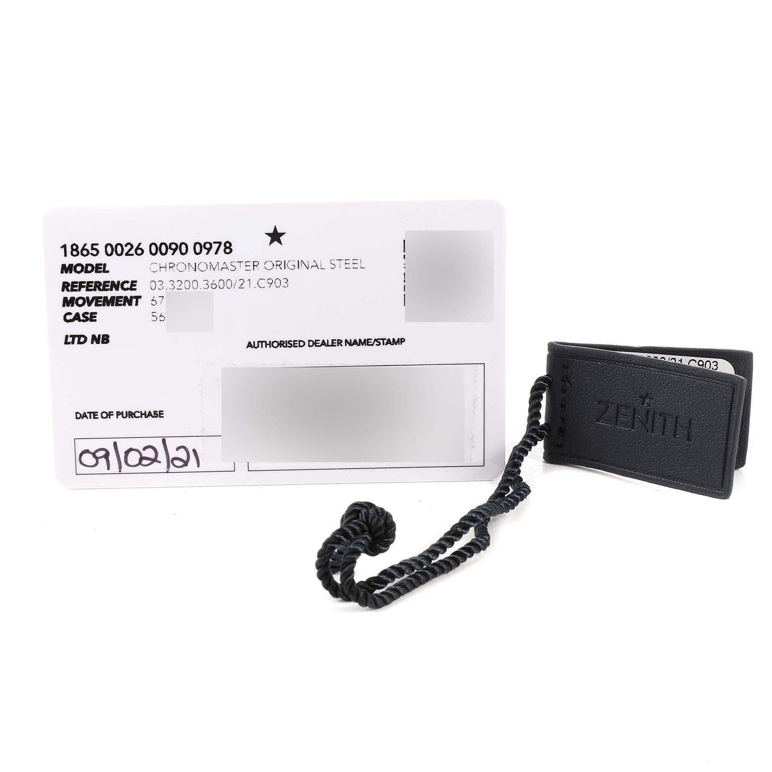 The image shows a Zenith Chronomaster 03.3200.3600/21.C903 Men
s Stainless Steel Black Dial 03.3200.3600/21.C903 Men
s Stainless Steel Black Dial model warranty card alongside a black Zenith tag with a braided cord.