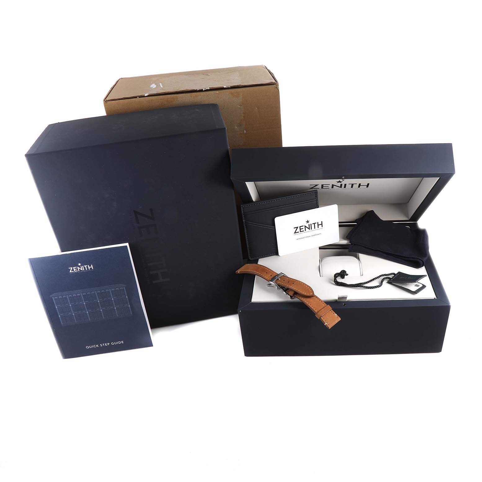 This image shows the packaging and accessories for a Zenith Chronomaster 03.3200.3600/21.C903 Men
s Stainless Steel Black Dial 03.3200.3600/21.C903 Men
s Stainless Steel Black Dial watch, including the box, manual, and additional straps.