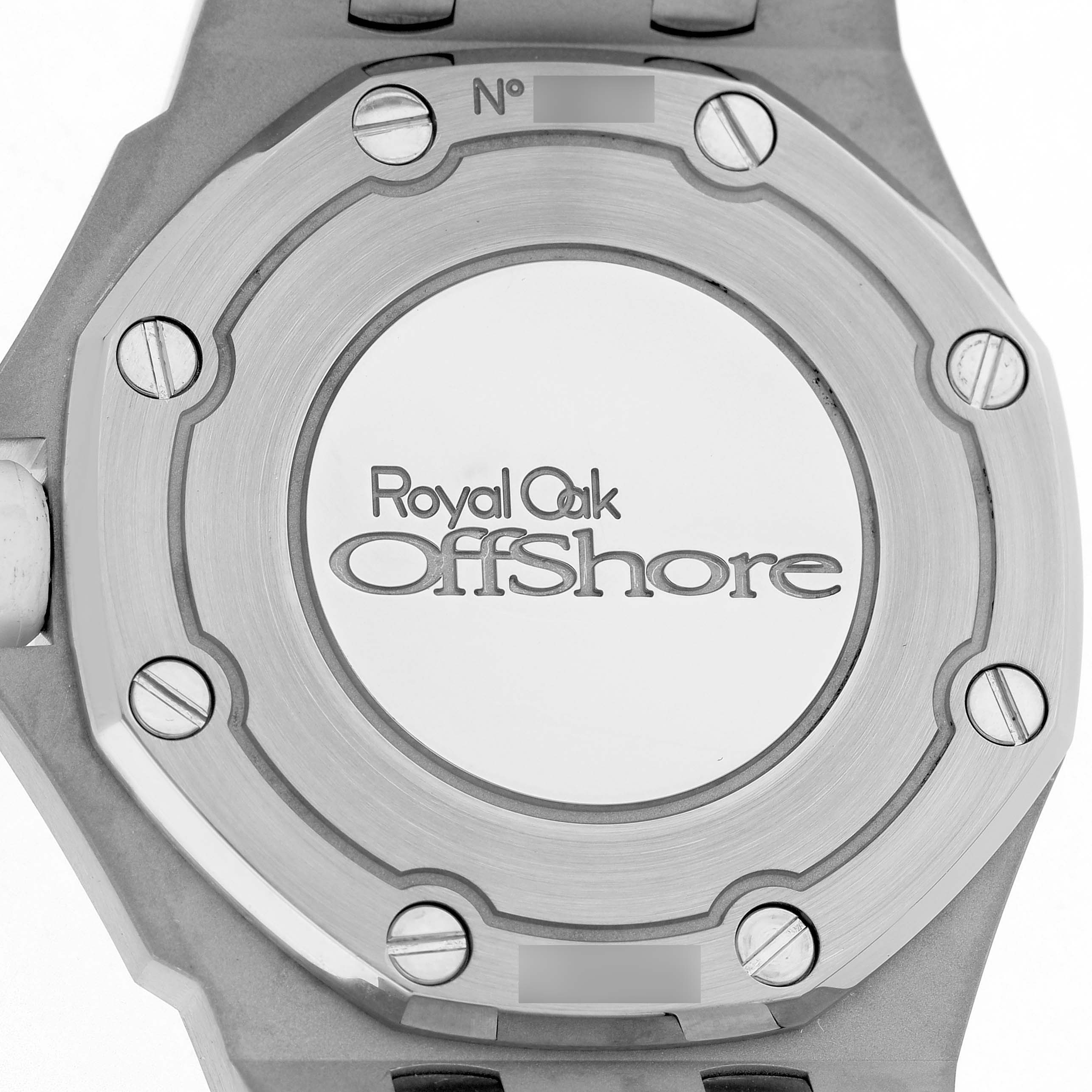 The image shows the back case of an Audemars Piguet Royal Oak Offshore 67540SK Women's Stainless Steel White Dial watch with visible screws and branding.