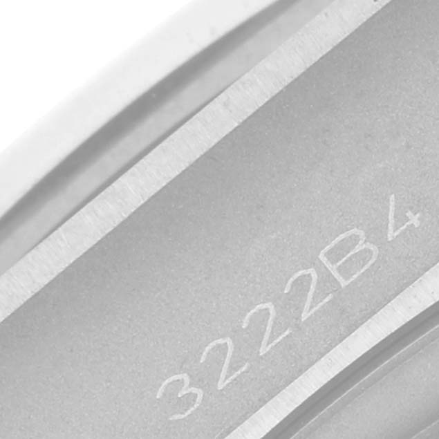 The image shows a close-up of the underside of the bezel of a Breitling Chronomat A32398 Men's Stainless Steel Green Dial A32398 Men's Stainless Steel Green Dial watch with part of a serial number visible.