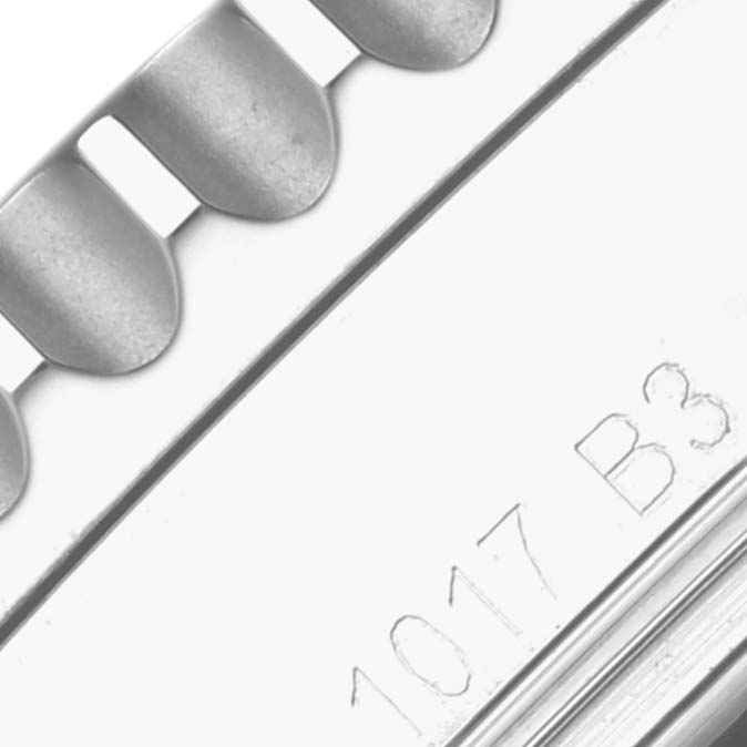 The image shows a close-up of the bezel edge and part of the case back, with engraved details, of a Breitling Navitimer AB012012/G826 Men's Stainless Steel White Dial AB012012/G826 Men's Stainless Steel White Dial watch.