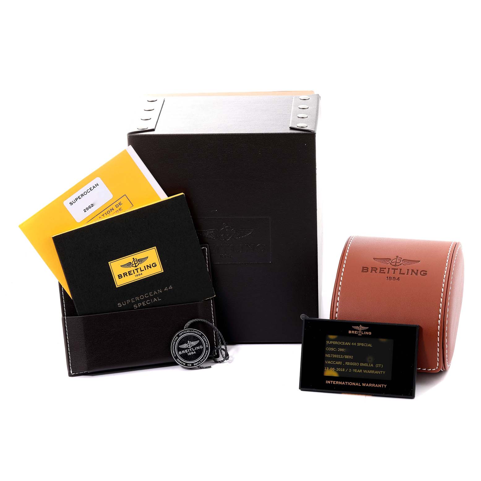The image shows accessories for a Breitling Superocean M17393 Men's Stainless Steel Black Dial M17393 Men's Stainless Steel Black Dial watch, including the box, manuals, warranty cards, and a leather case.