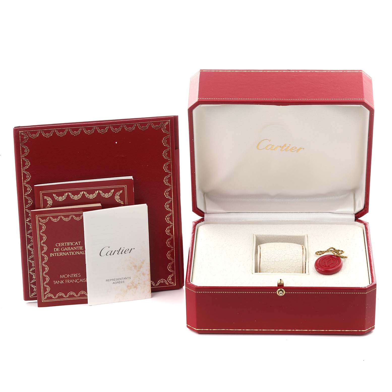 The image shows the Cartier Tank Française watch box, warranty booklet, and accompanying accessories from a front angle.