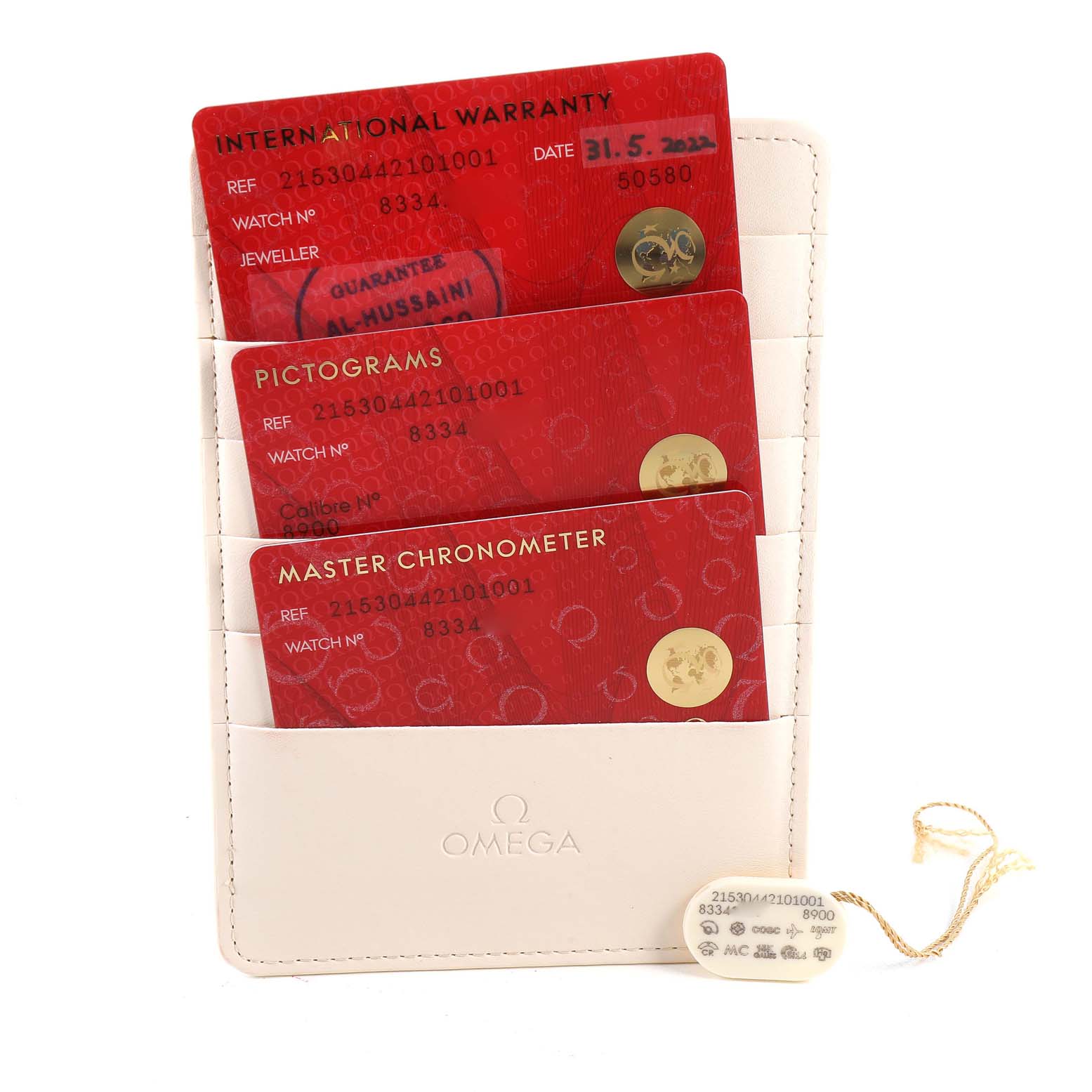 The image shows the warranty cards and tags for an Omega Planet Ocean 215.30.44.21.01.001 Men
s Stainless Steel Black Dial 215.30.44.21.01.001 Men
s Stainless Steel Black Dial model, neatly arranged in a white Omega cardholder.