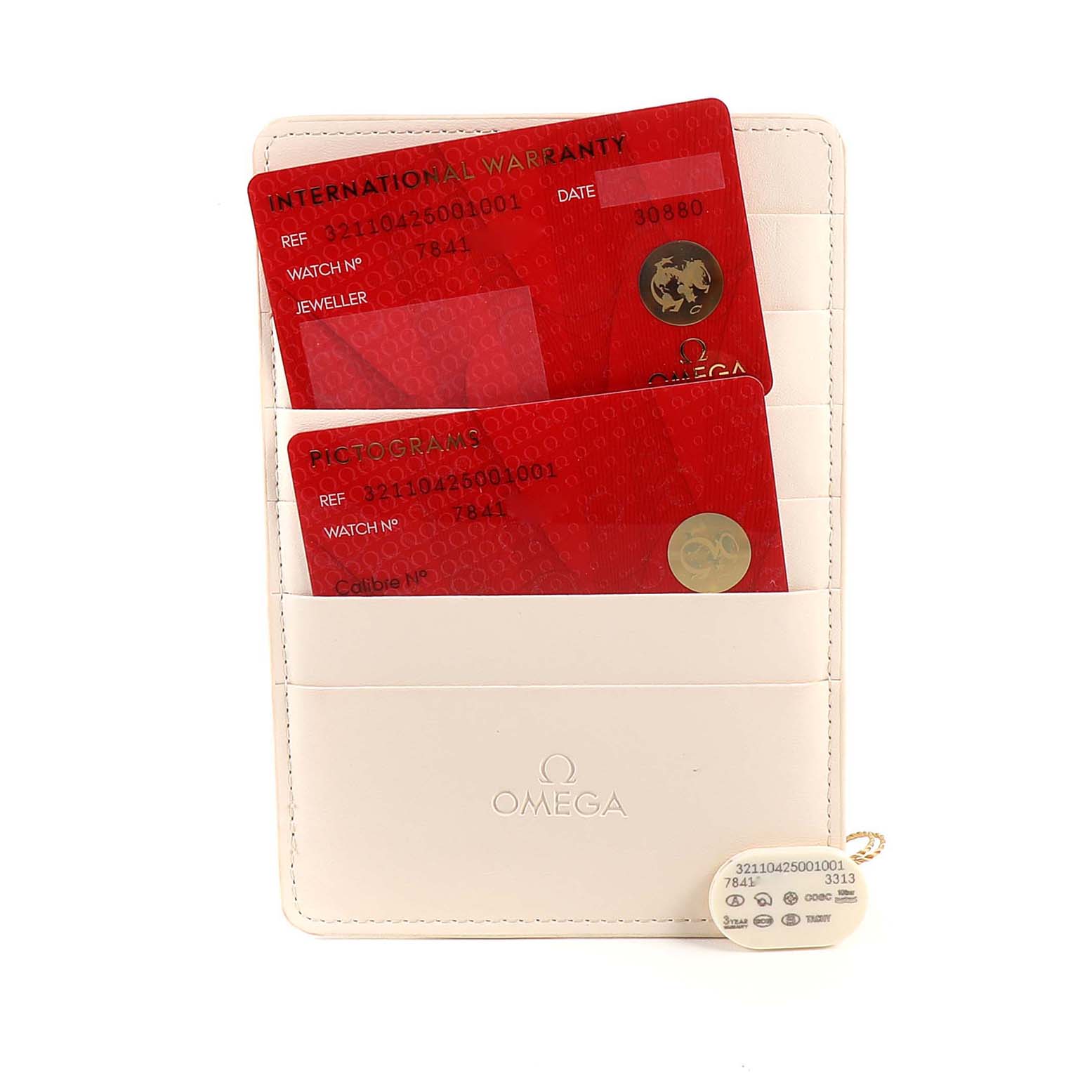 This image shows the warranty cards and a tag for an Omega Speedmaster 321.10.42.50.01.001 Men's Stainless Steel Black Dial 321.10.42.50.01.001 Men's Stainless Steel Black Dial, displayed in a cream-colored cardholder.