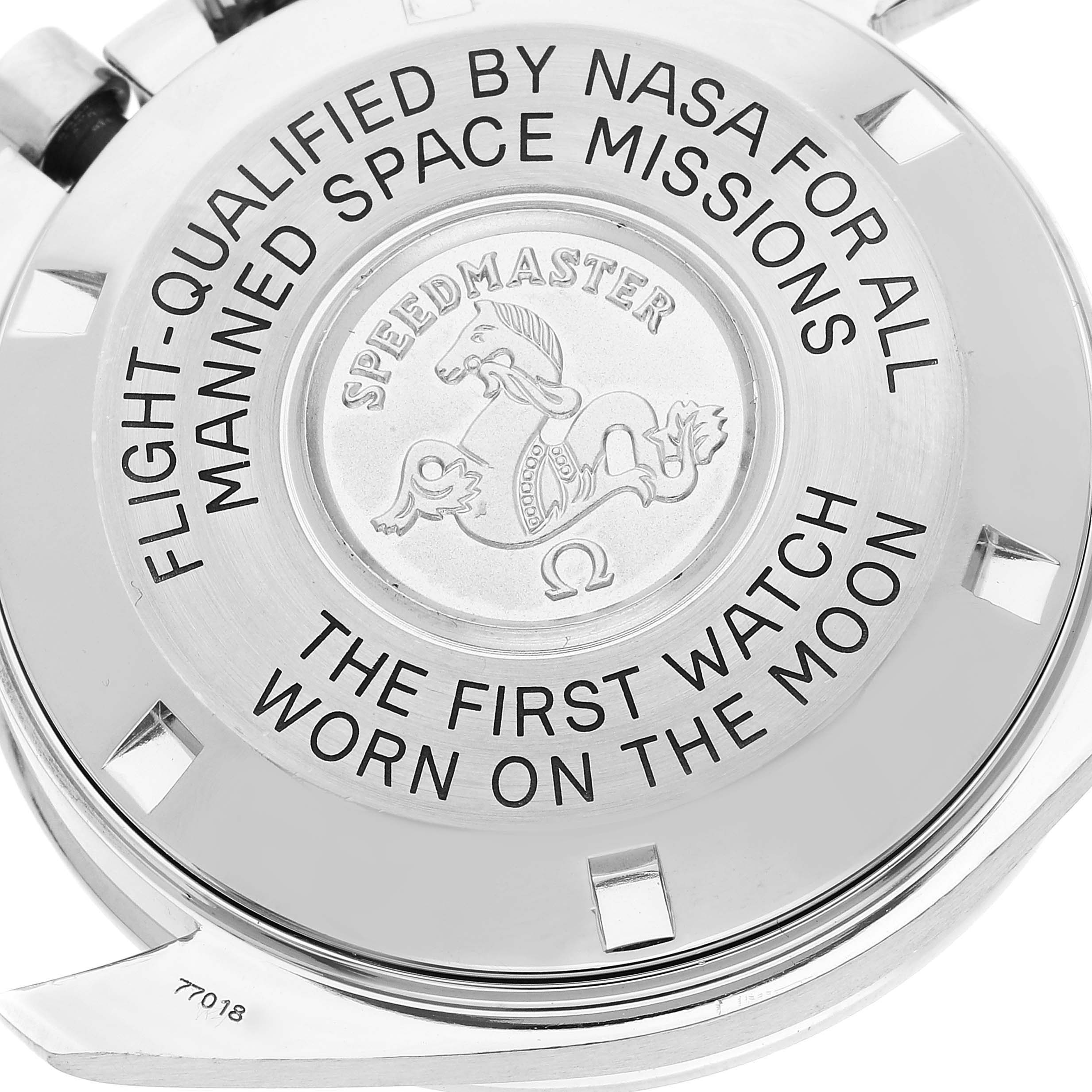 This image shows the case back of an Omega Speedmaster 3570.50.00 Men's Stainless Steel Black Dial 3570.50.00 Men's Stainless Steel Black Dial watch with inscriptions about its NASA qualification and moon landing history.