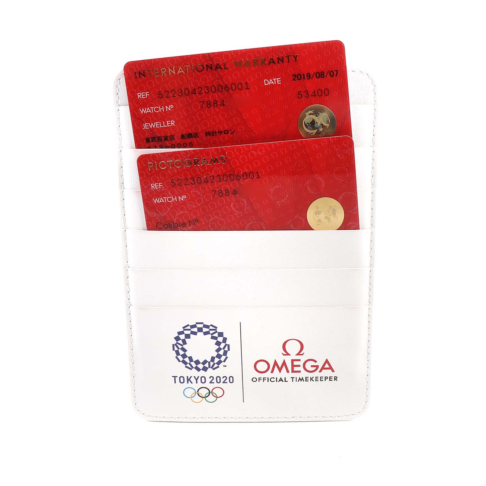 The image shows Omega Speedmaster 522.30.42.30.06.001 Men's Stainless Steel Silver Dial 522.30.42.30.06.001 Men's Stainless Steel Silver Dial's International Warranty and Pictograms cards in a white cardholder, branded for the Tokyo 2020 Olympics.